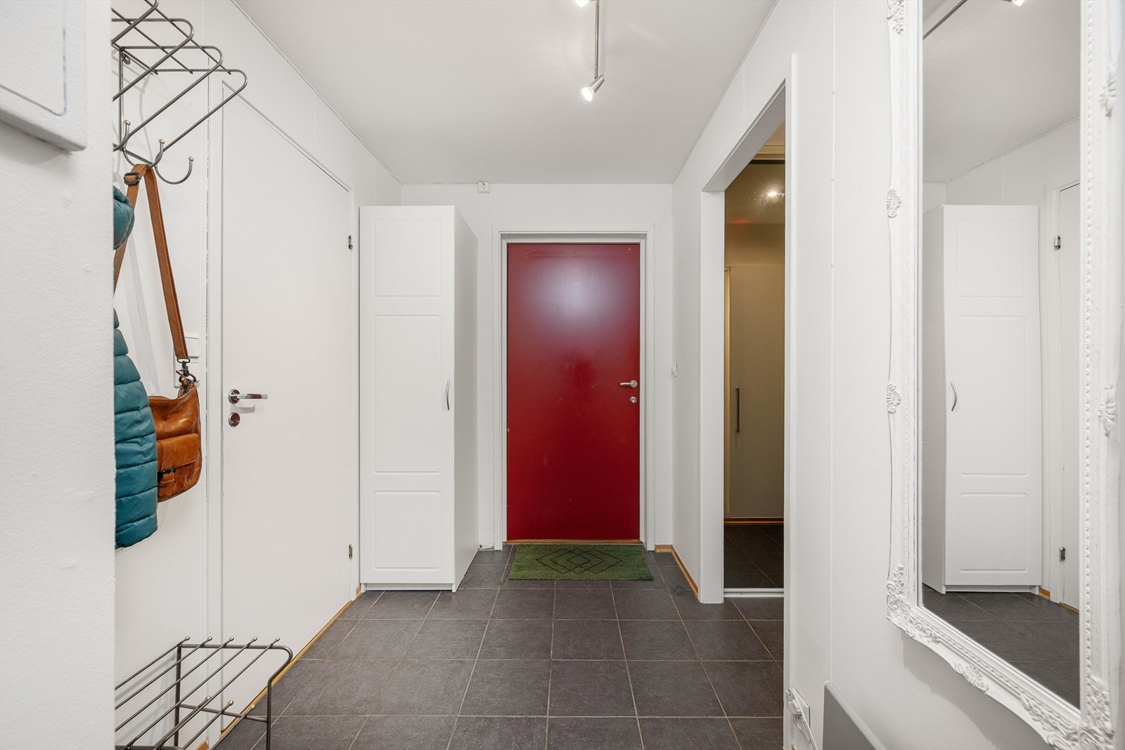 Leiligheten har trappefri adkomst inn til felles trapperom og videre inn i en romslig entré med flislagt gulv. Galleribilde