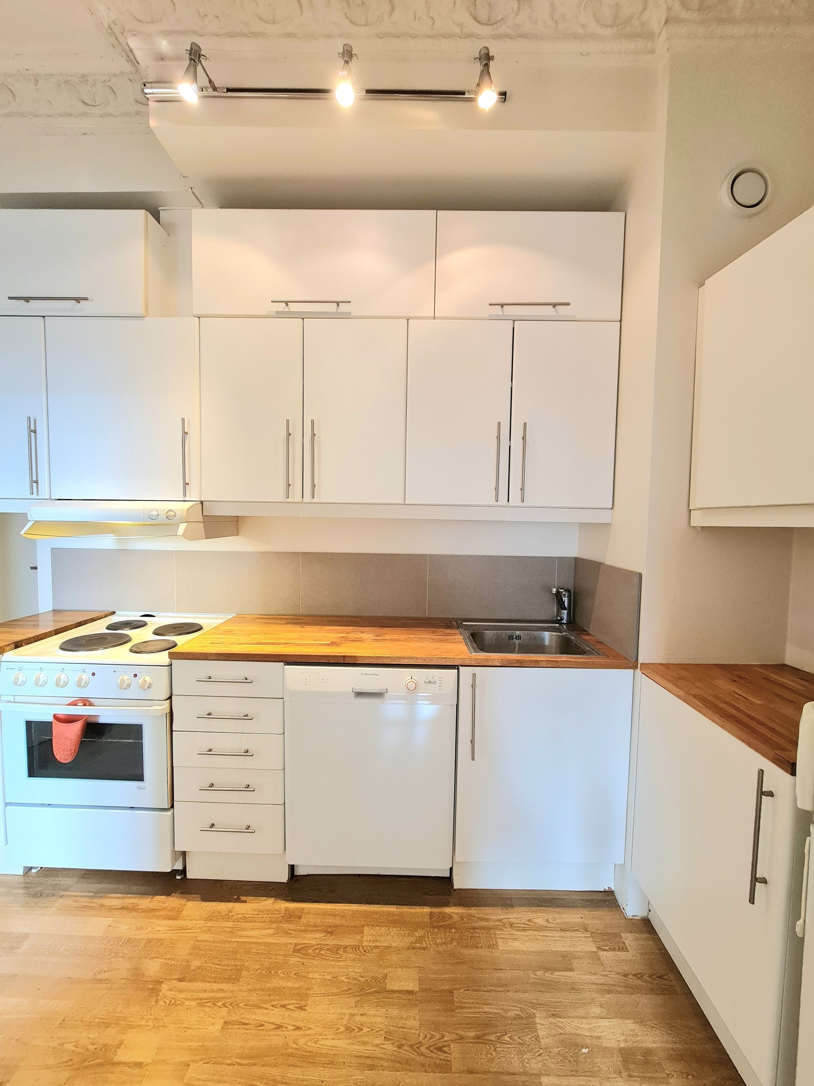 Lys kjøkkeninnredning med mye skapplass Galleribilde