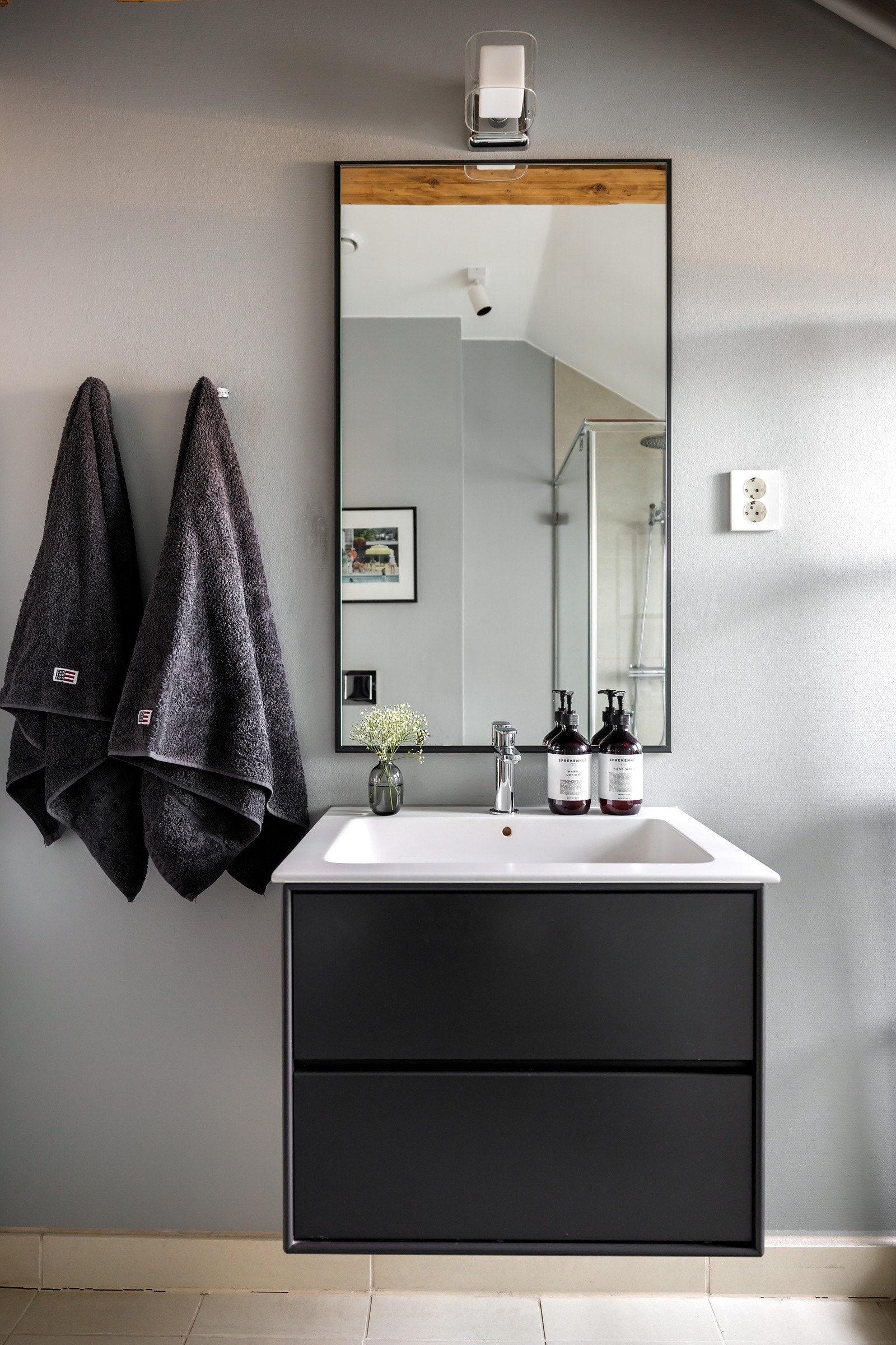 Mantena baderomsinnredningen har sorte, glatte fronter og består av en heldekkende servant på en skuffeseksjon, stort speil med belysing over og vegghengt toalett. Badet har også opplegg for vaskemaskin Galleribilde