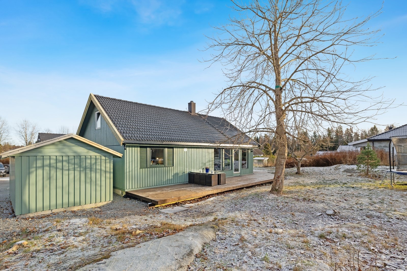 Vestvendt og solrik terrasse. Bruksplen og noe naturtomt. Galleribilde