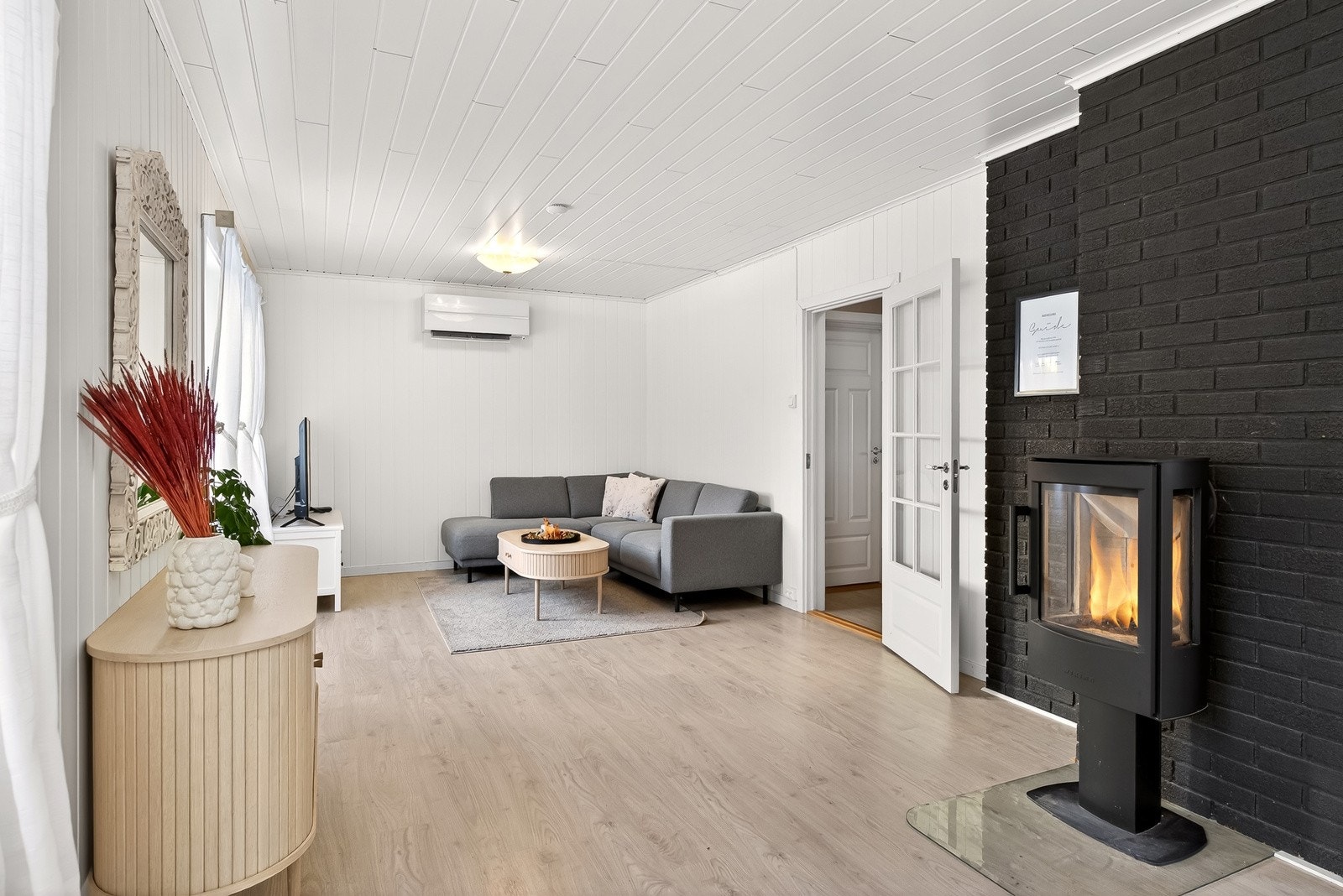 Tidsriktig og innbydende i behagelige og varme toner. Det er både varmepumpe og vedovn i stuen. Galleribilde