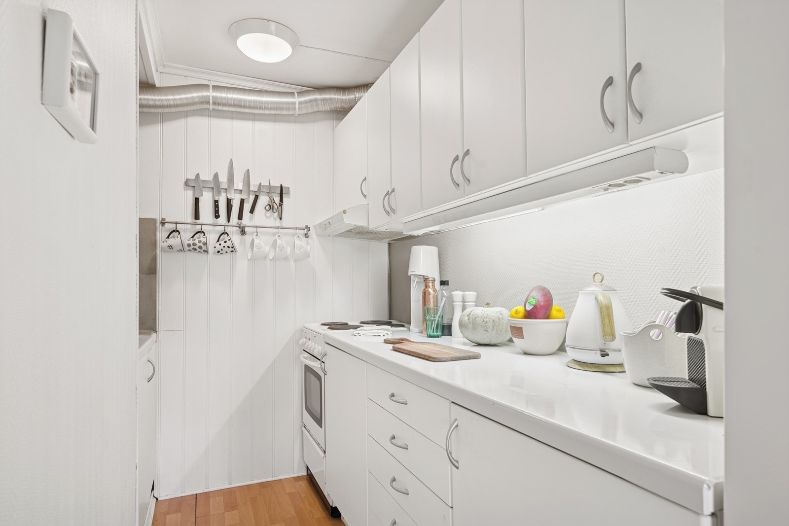 Kjøkkenet har innredning med lyse, glatte fronter og laminat benkeplate. Galleribilde