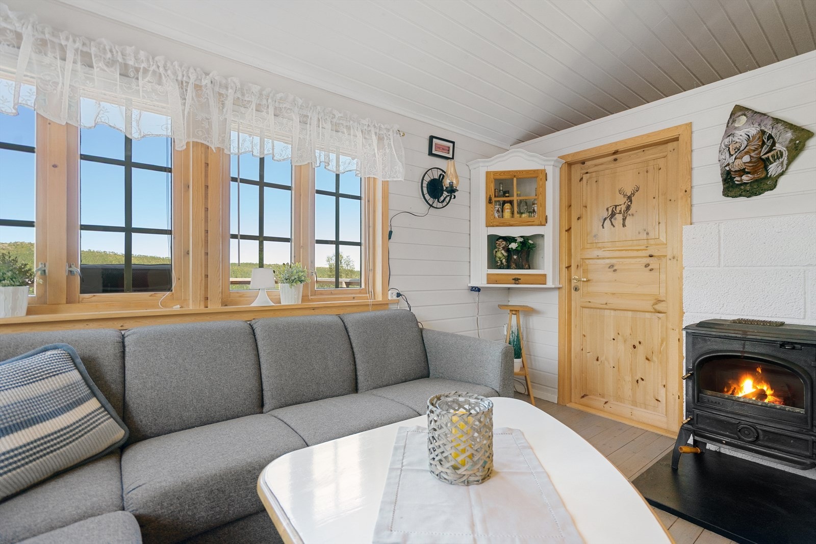 Stuen er utstyrt med vedfyring, fra stue har du adkomst til soverom Galleribilde