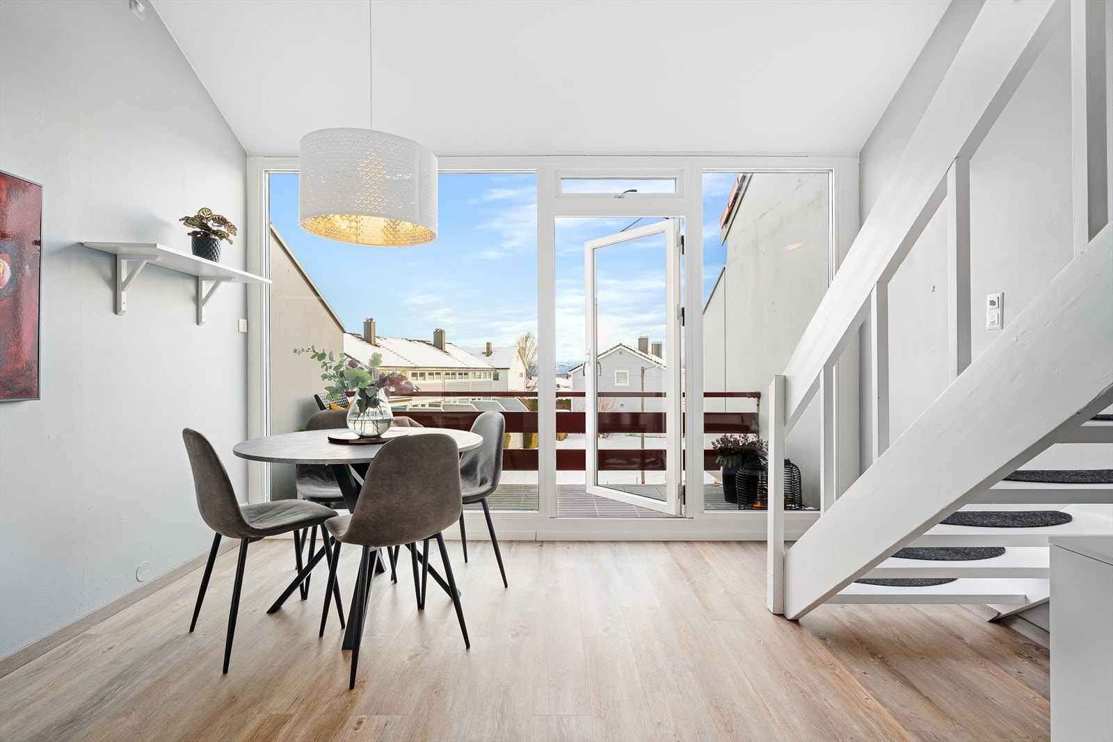 Ved spisebordet er det store vinduer som gir godt naturlig dagslys og flott utsikt med glimt av sjø og fjell. Galleribilde