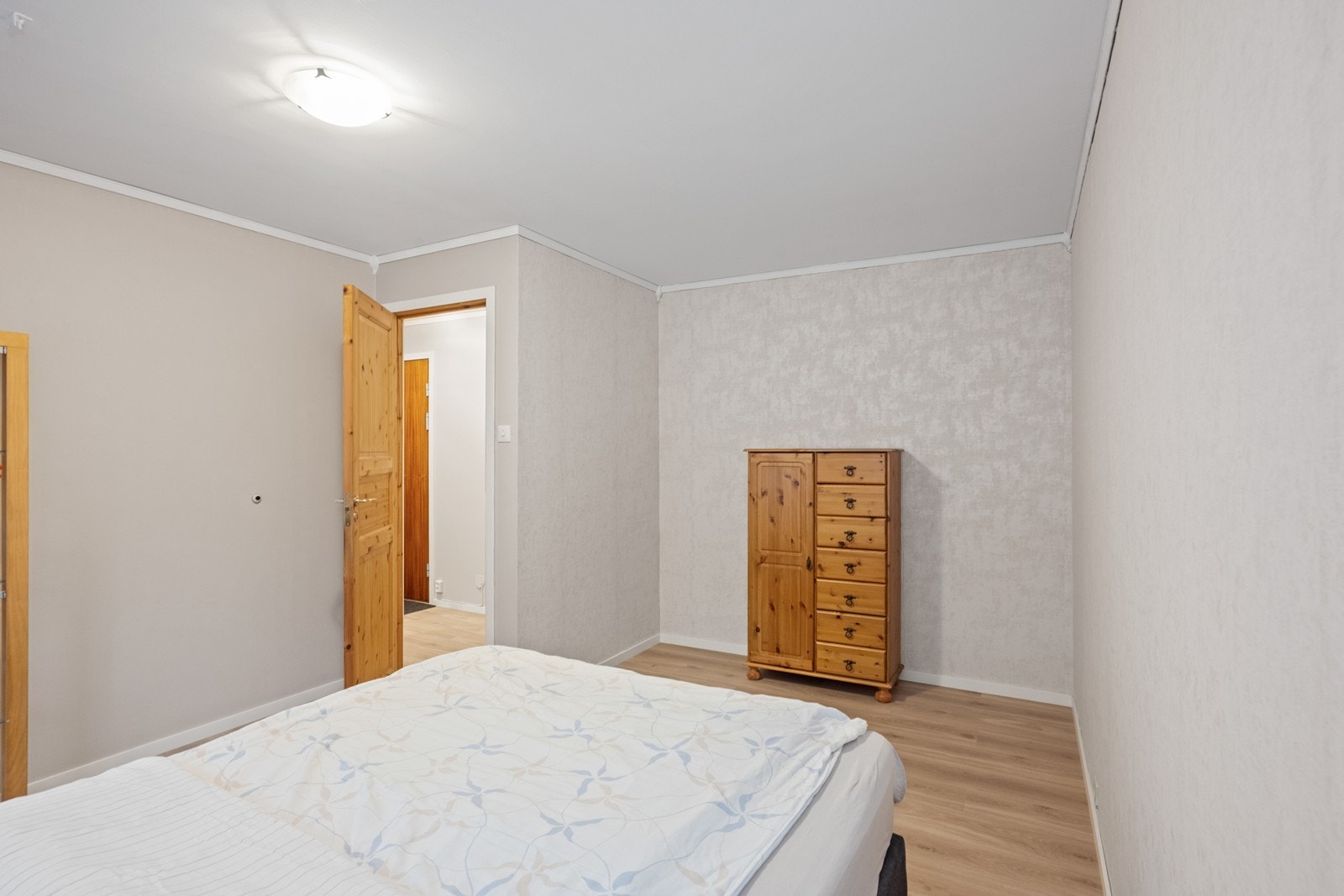 Soverommet har tapetserte vegger og plass til oppbevaringsmøbler. Galleribilde