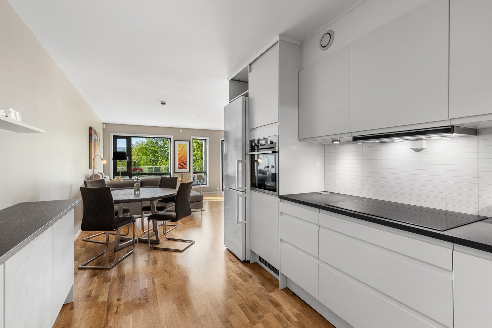 Et moderne og funksjonelt kjøkken med tidsriktige løsninger, god skapplass og naturlig lys fra store vindusflater. Galleribilde