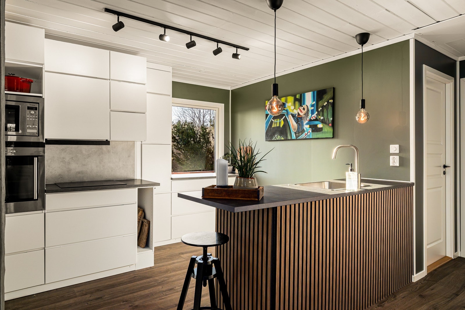 Et lyst og lekkert kjøkken med slette fronter Galleribilde