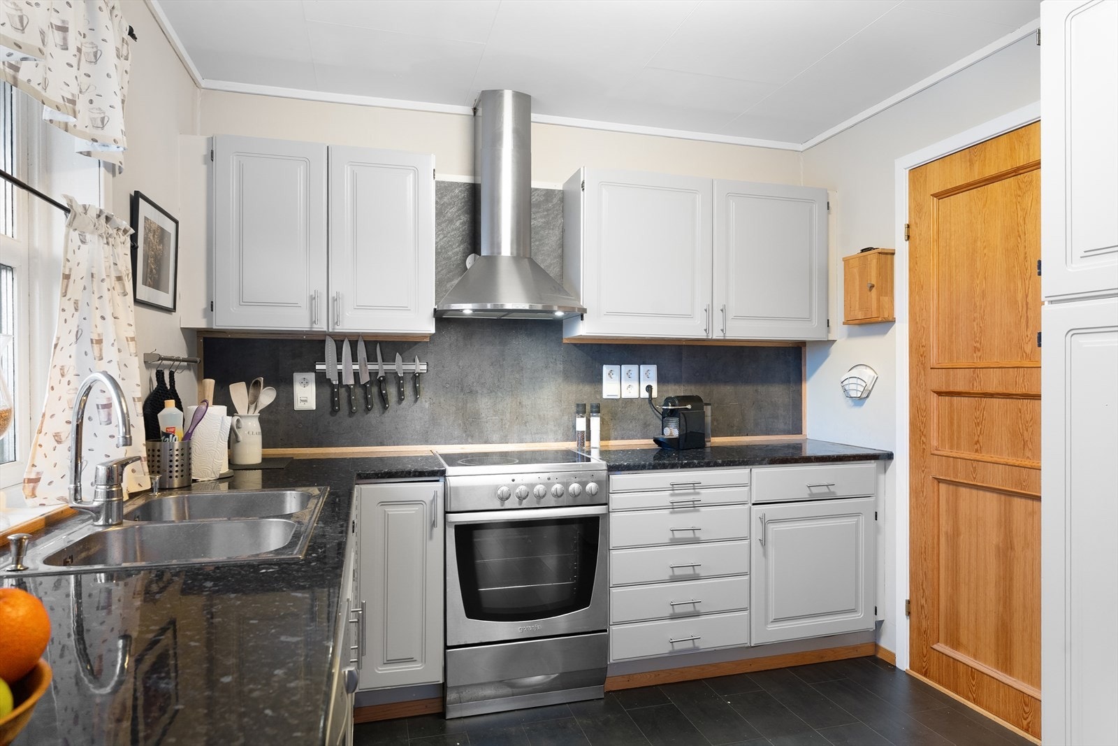 Pent og tidløst kjøkken med god skap- og benkeplass Galleribilde