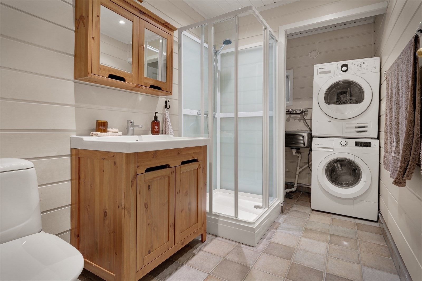 Praktisk vaskerom-nisje med utslagsvask og opplegg for vaskemaskin og tørketrommel. Galleribilde