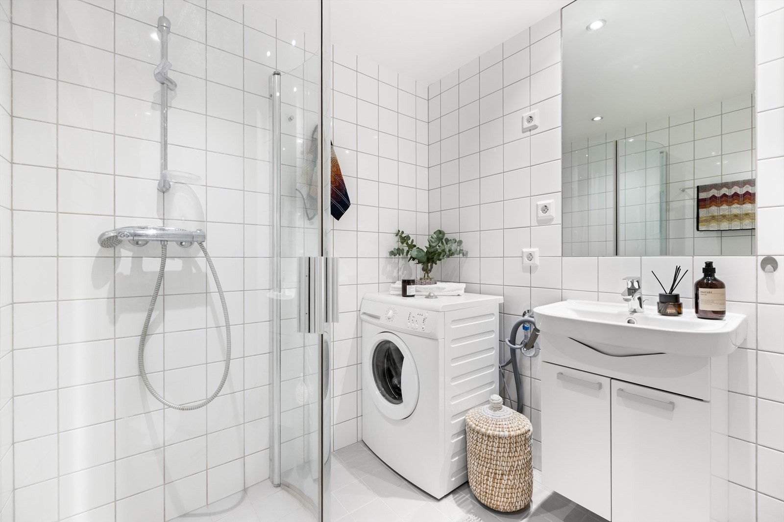 Badet er innredet med vegghengt toalett, baderomsinnredning med heldekkende servant, speil og dusjvegger. Galleribilde