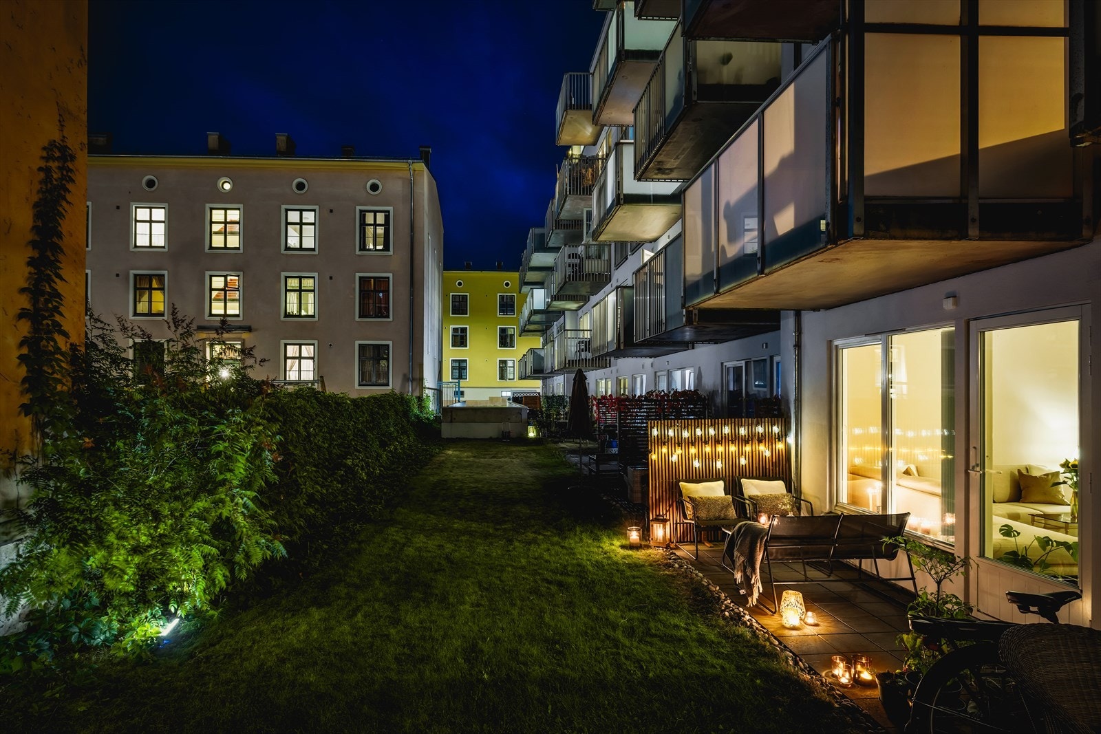 Kveldslys og grønt uteområde i forlengelsen av terrassen gir en romslig og luftig følelse. Galleribilde