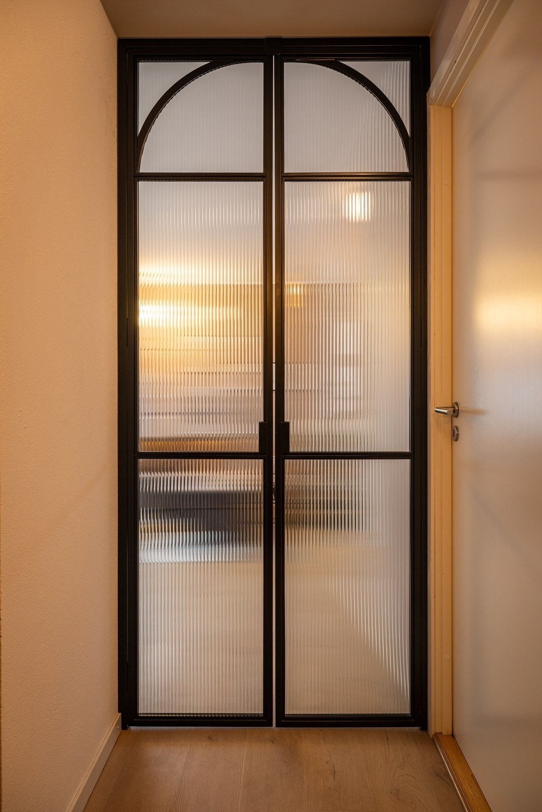 Legg merke til at buen på smijernsdøren harmonerer med buen på den stedbygde nisjen på kjøkkenet. Galleribilde