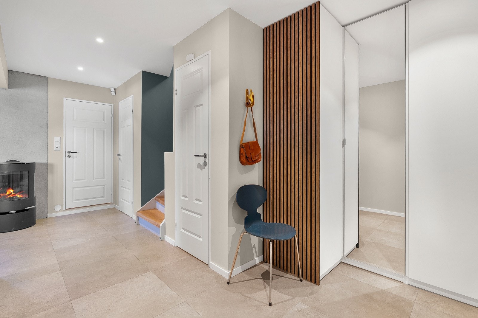 Her er det moderne overflater, varme i gulvet, peisovn og god plass til alt av ytterklær og sko. Galleribilde