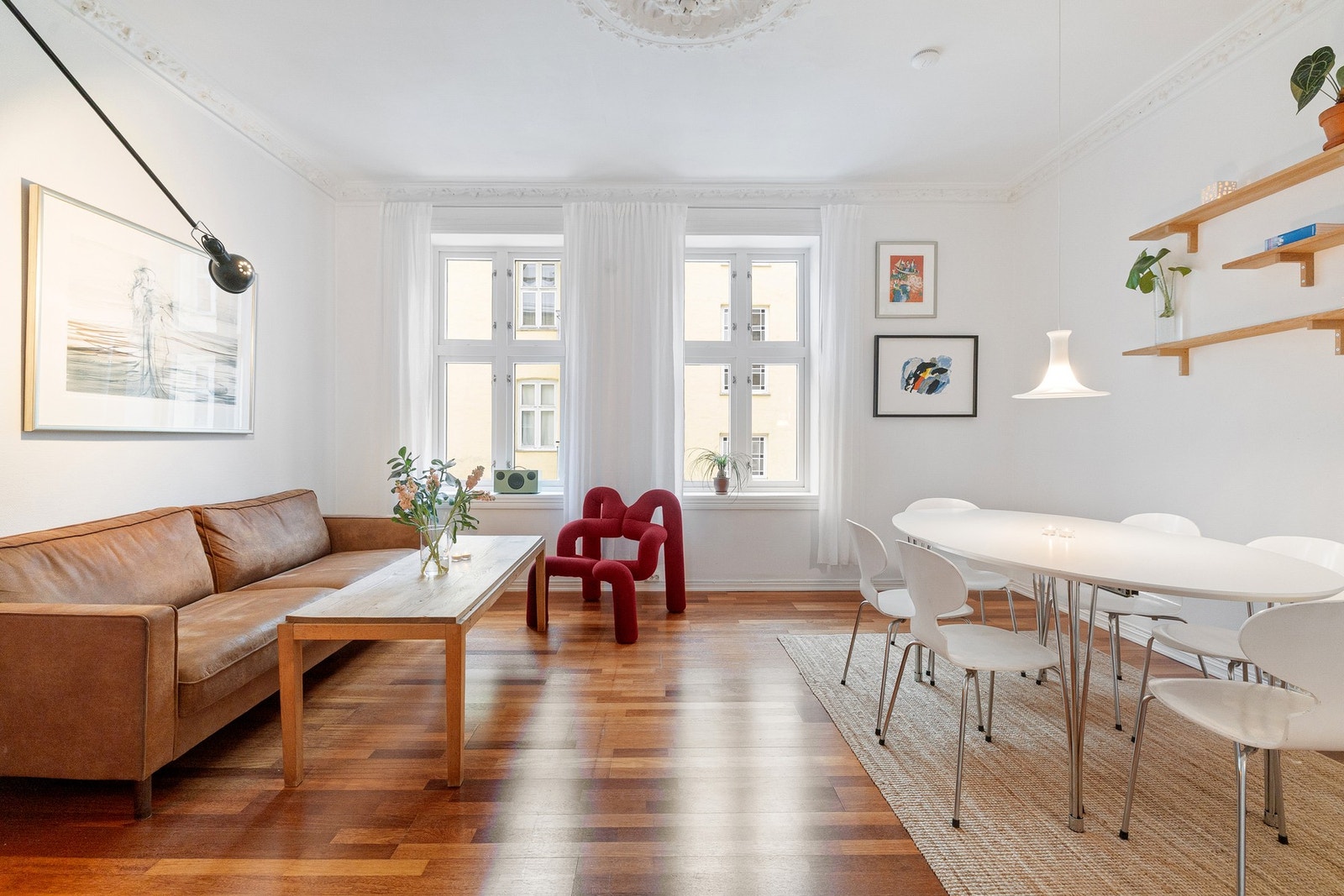 Store vindusflater slipper rikelig med dagslys inn. På sommerstid faller morgensol samt formiddagssol vakkert over hustakene og inn i stuen. Galleribilde