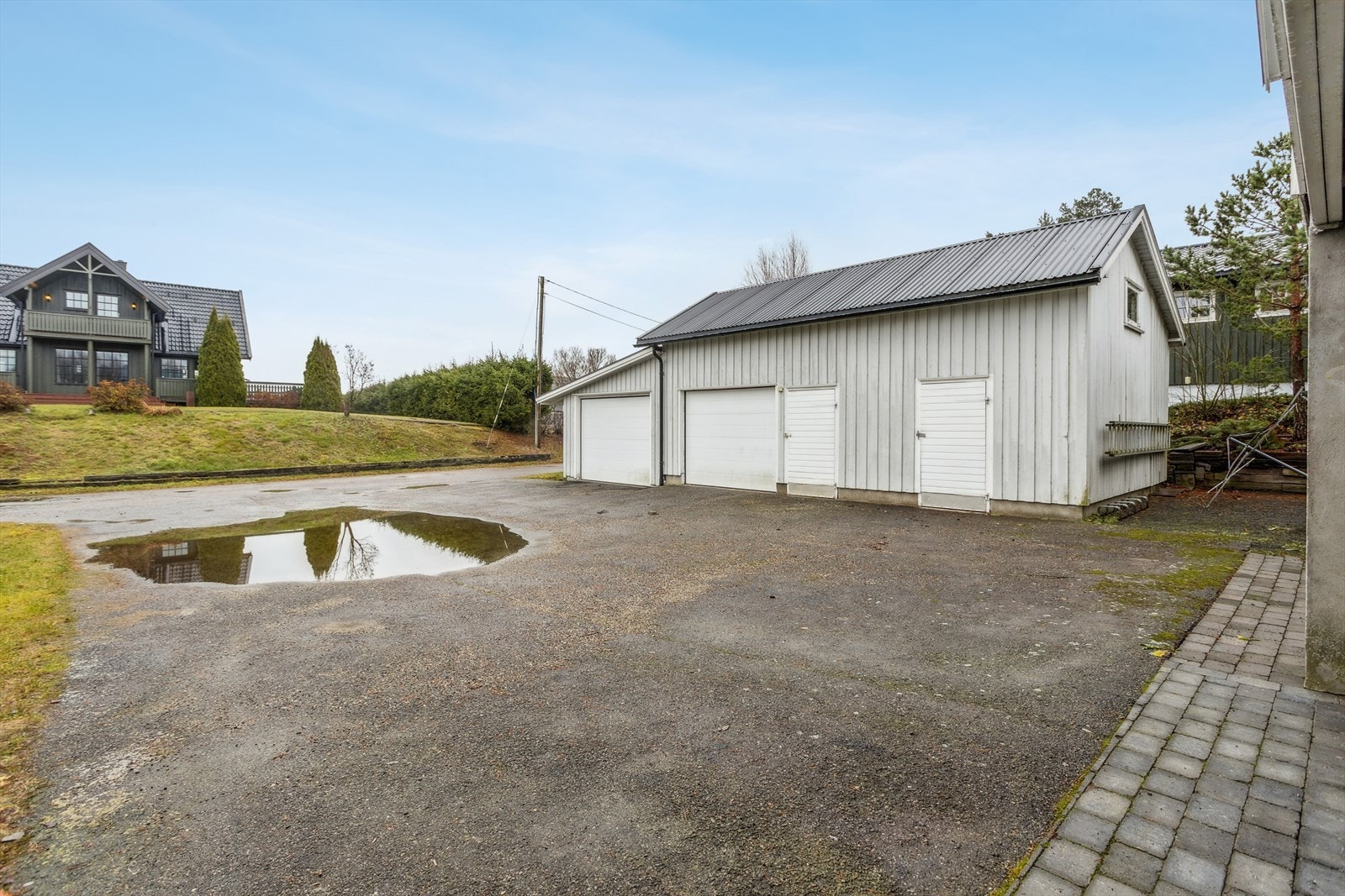 Garasjebygget har to separate garasjerom med leddede porter og automatikk. Galleribilde