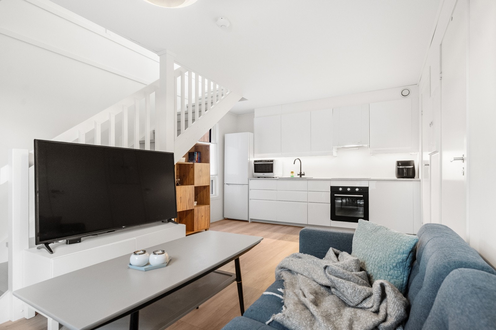 Kjøkkenet har moderne innredning med glatte fronter, laminert benkeplate og integrerte hvitevarer. Galleribilde