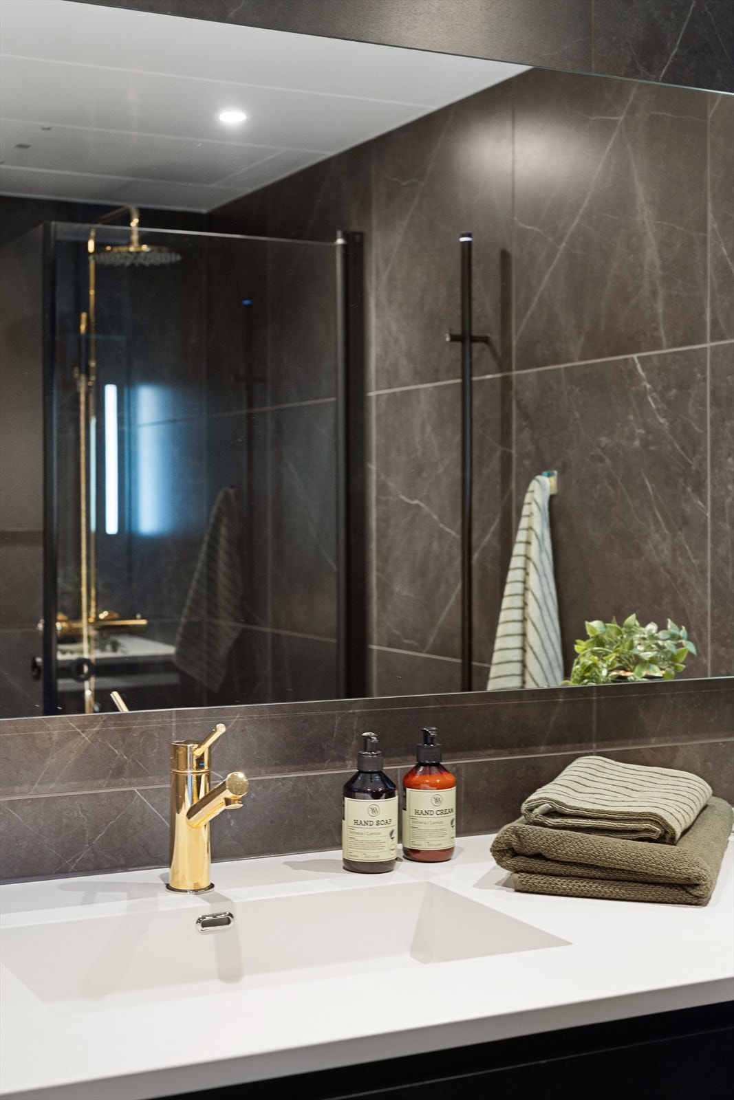 Badet har et stort speil som åpner opp rommet. Downlights i taket. Galleribilde