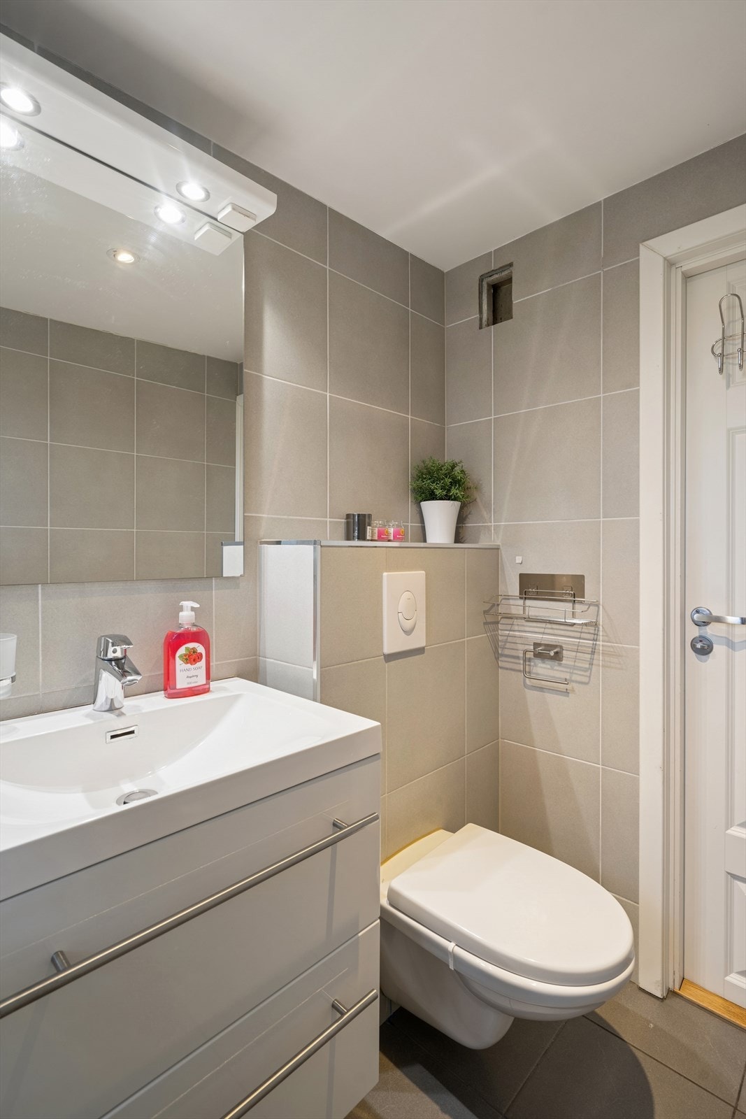 Badet er ellers utstyrt med dusjnisje, vegghengt toalett og baderomsinnredning med nedfelt servant. Galleribilde