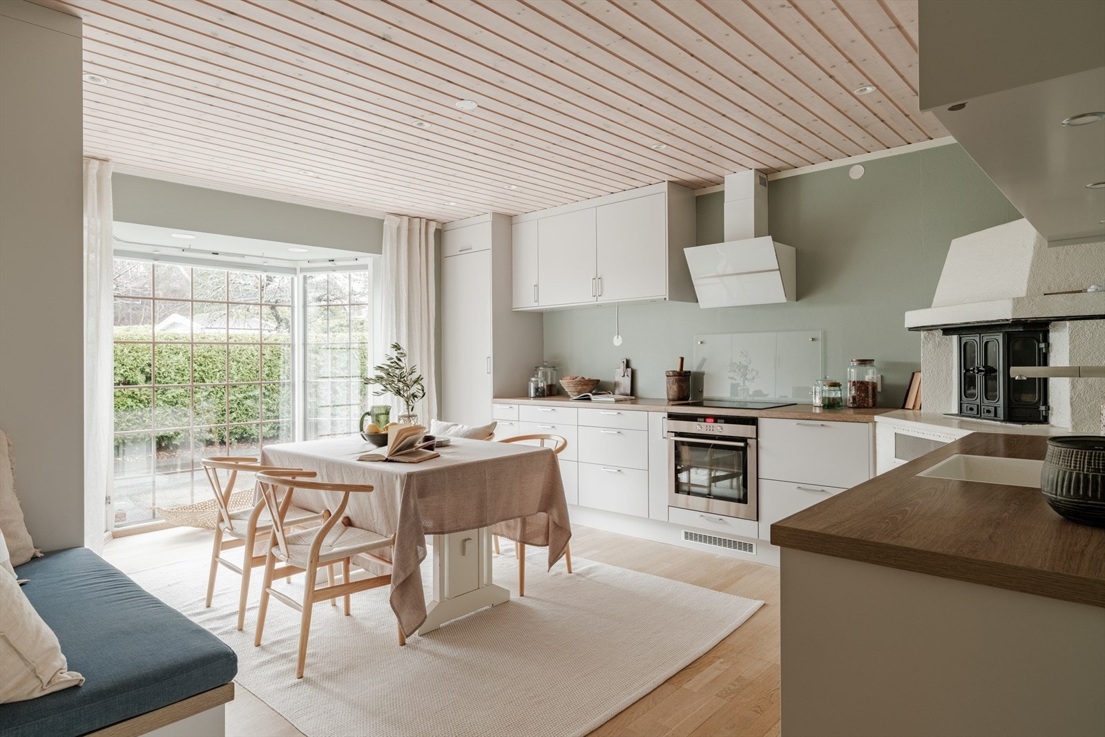 Kjøkkenet har parkettgulv med gulvvarme, malt tapet på vegger og panel i himling med downlights. Galleribilde