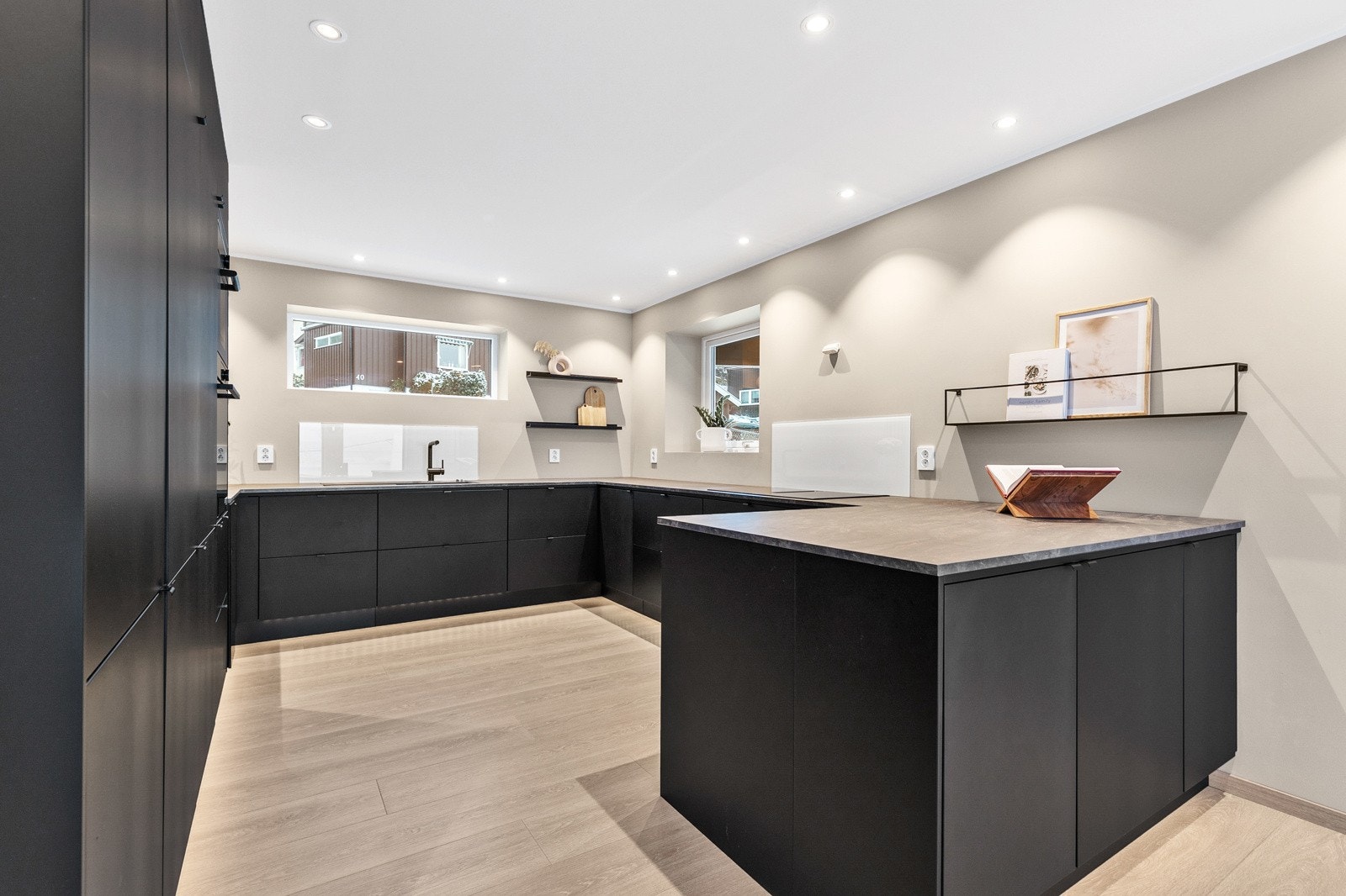 Kjøkkenet har moderne innredning med mye skap- og benkeplass. Galleribilde