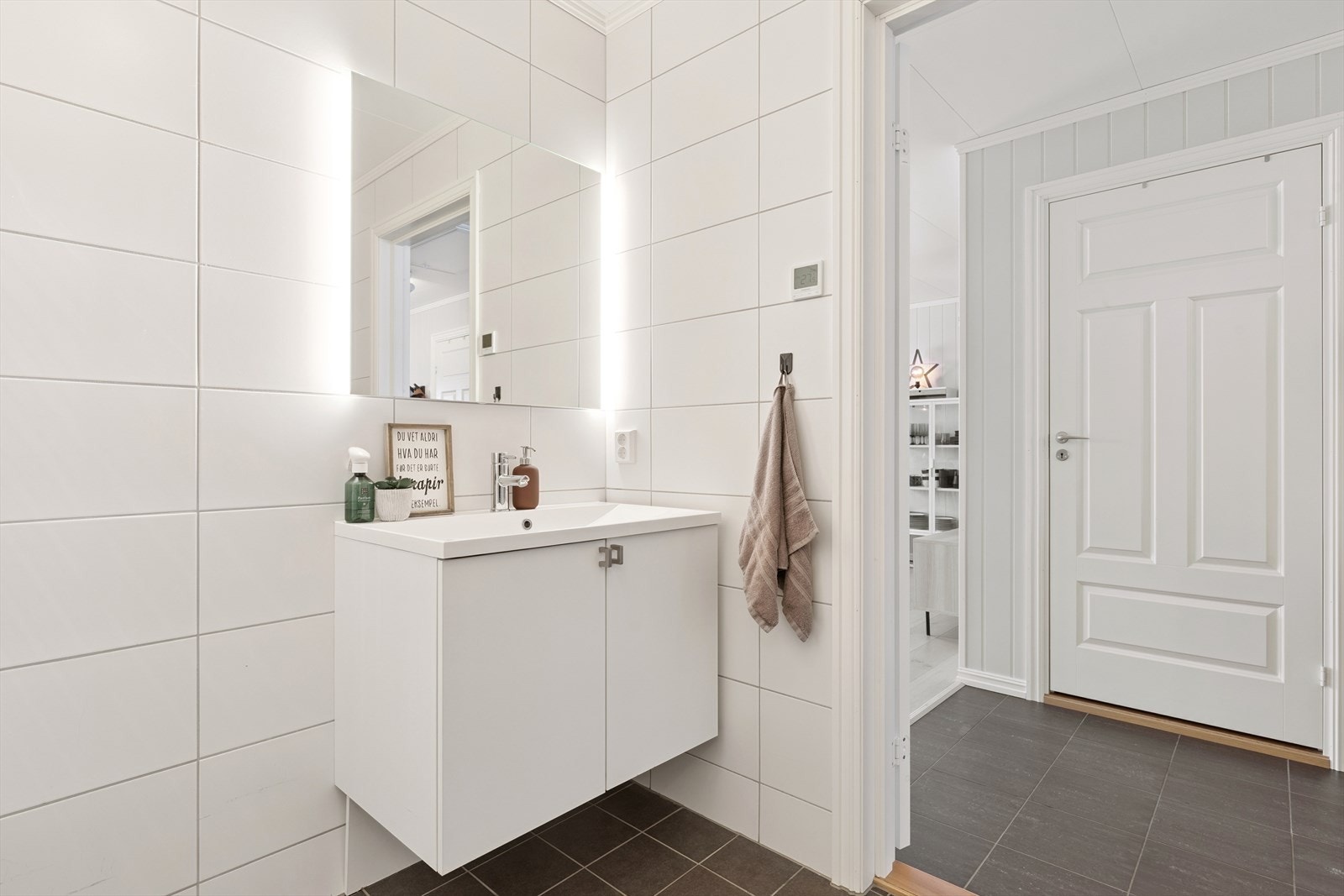 Innredningen består av et vegghengt servantskap og speil med integrert belysning. Galleribilde