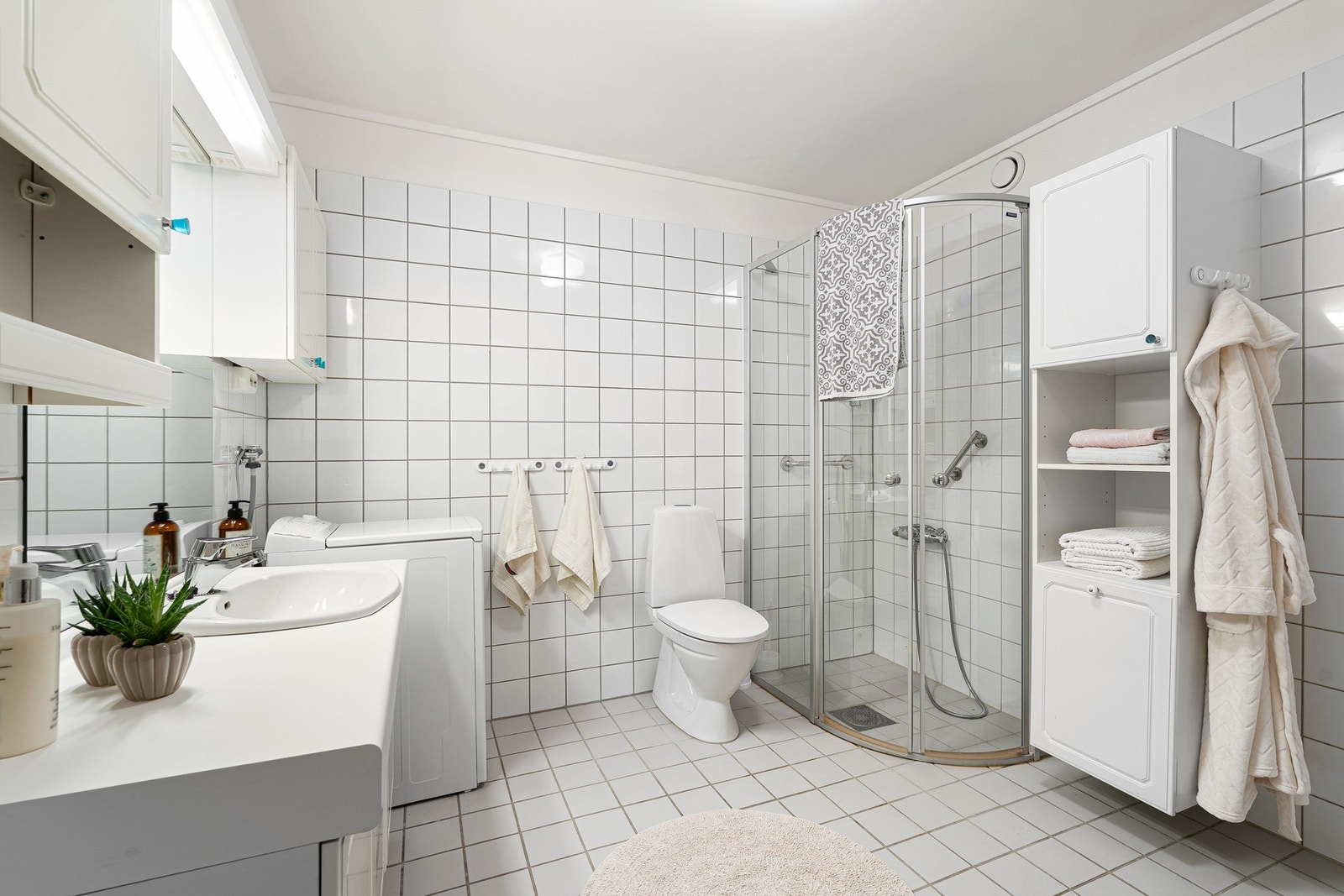 Badet er utstyrt med servantinnredning, gulvmontert toalett og dusjhjørne. Galleribilde