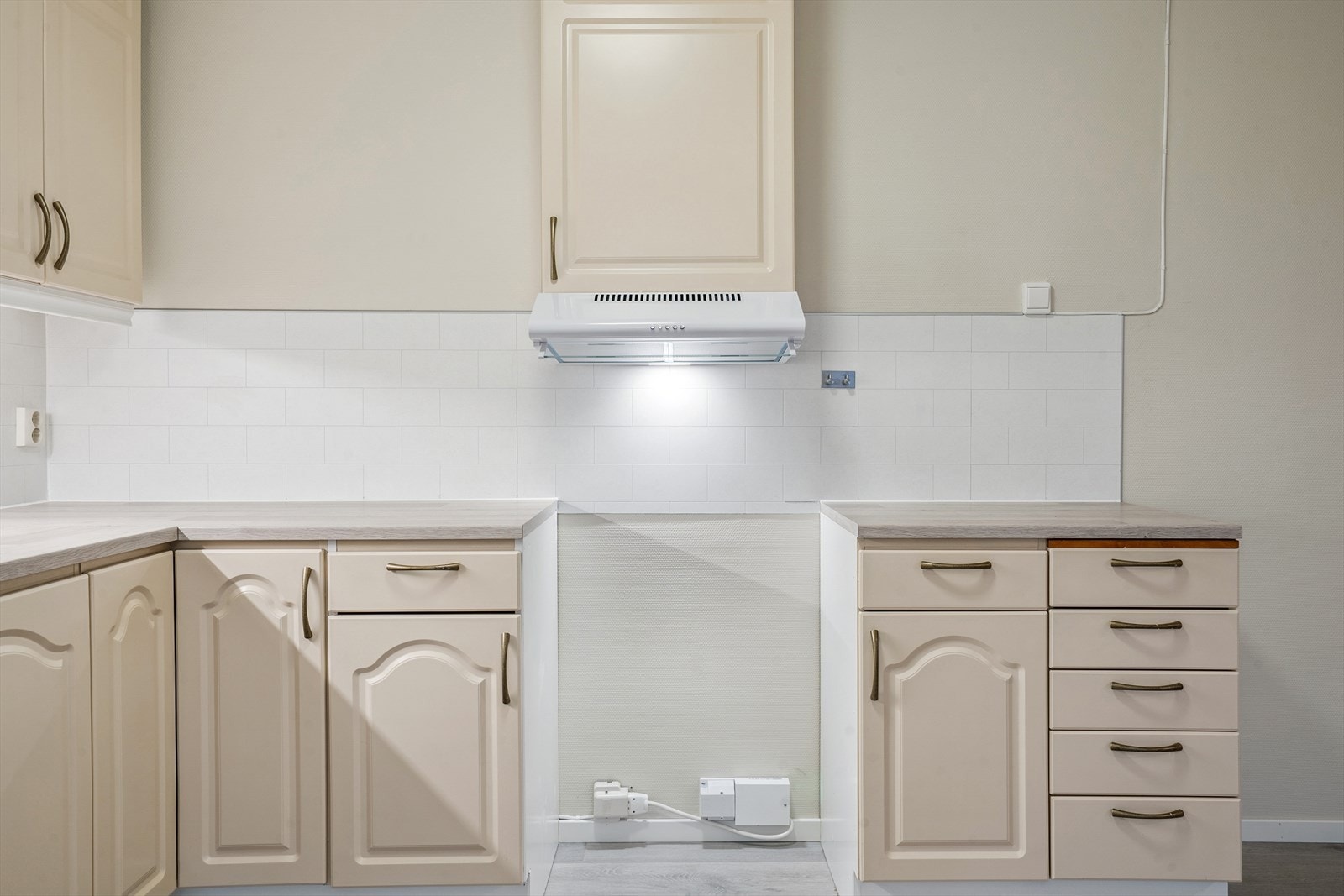 Kjøkkeninnredningen har laminat benkeplate, kitchen wall mellom benk og overskap, opplegg for komfyr og ventilator. Galleribilde