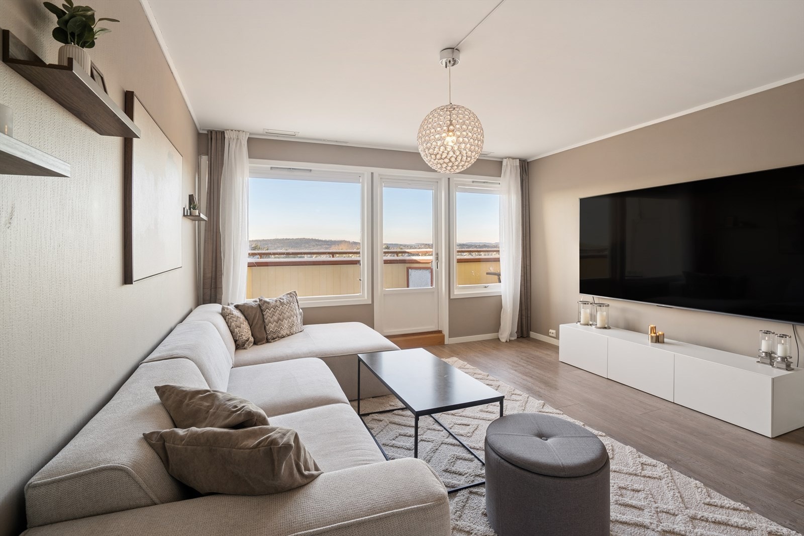 Store vinduer fyller stuen med naturlig lys, og herfra har du direkte utgang til boligens andre balkong. Galleribilde