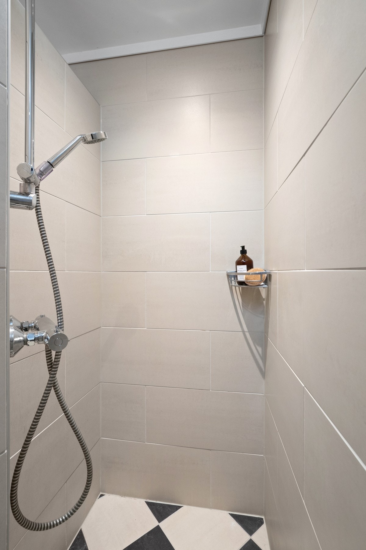 Badet har vegghengt toalett, dusjhjørne og mekanisk avtrekk. Galleribilde