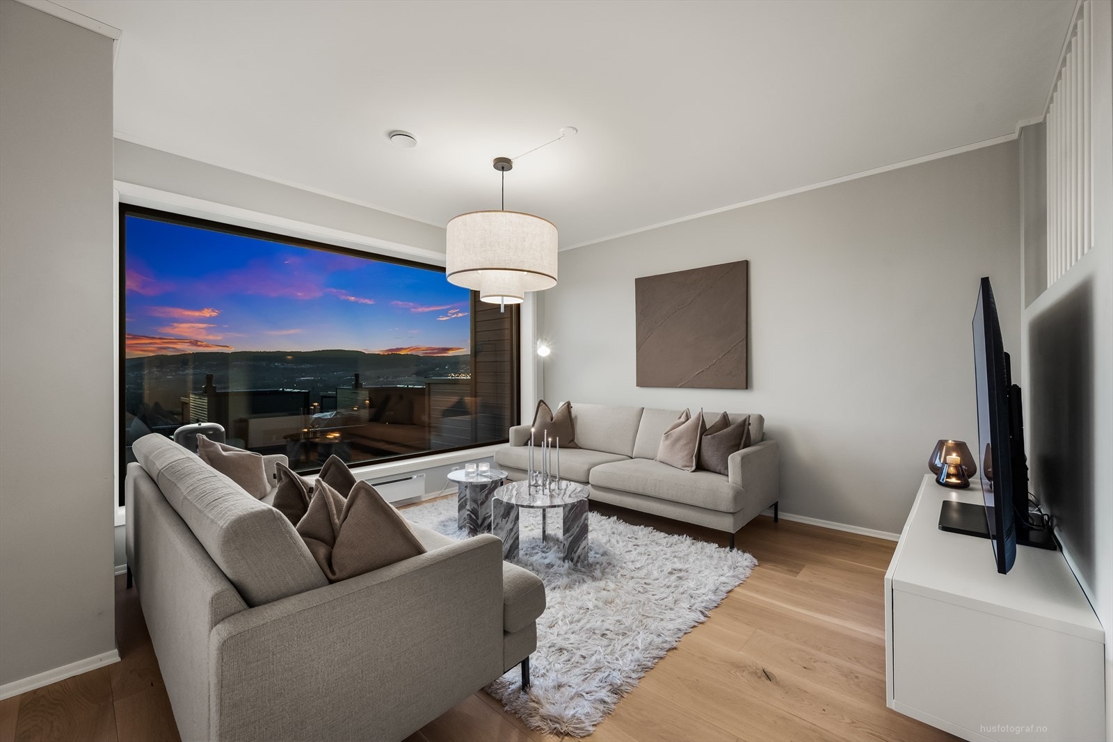 Her er det plass til sofa, bord og tv benk. De store vinduene slipper inn mye naturlig lys. Galleribilde