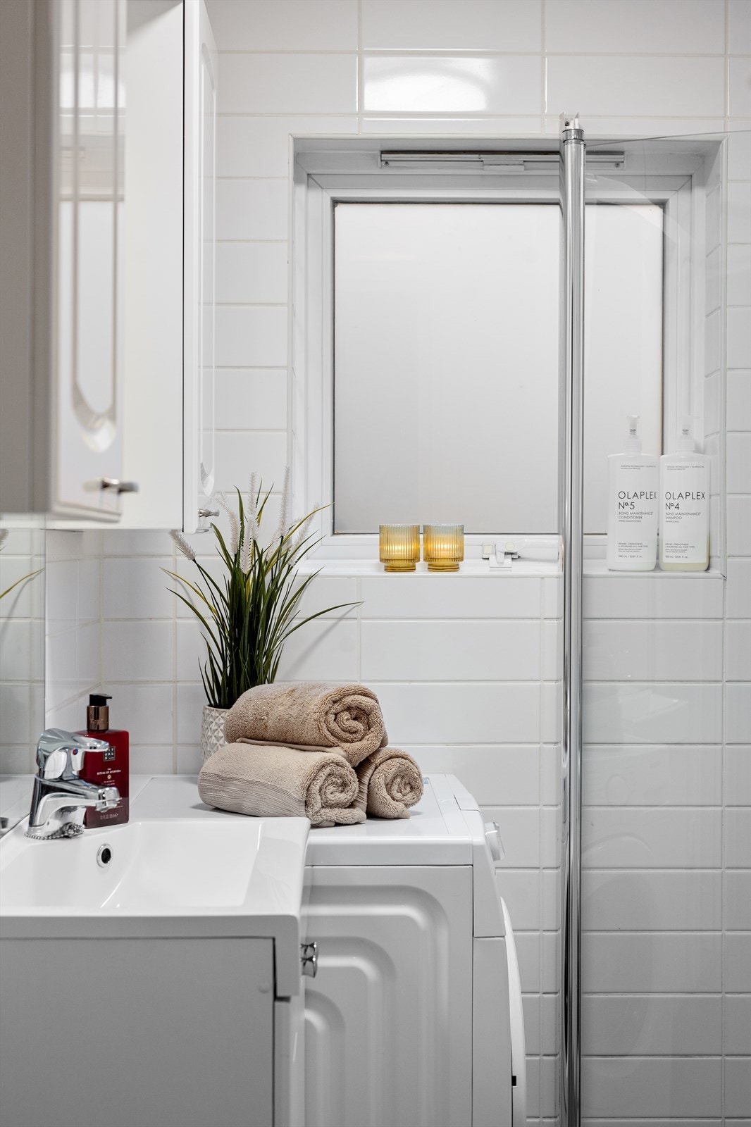 Rommet er praktisk innredet med servant, veggskap og opplegg for vaskemaskin. Galleribilde