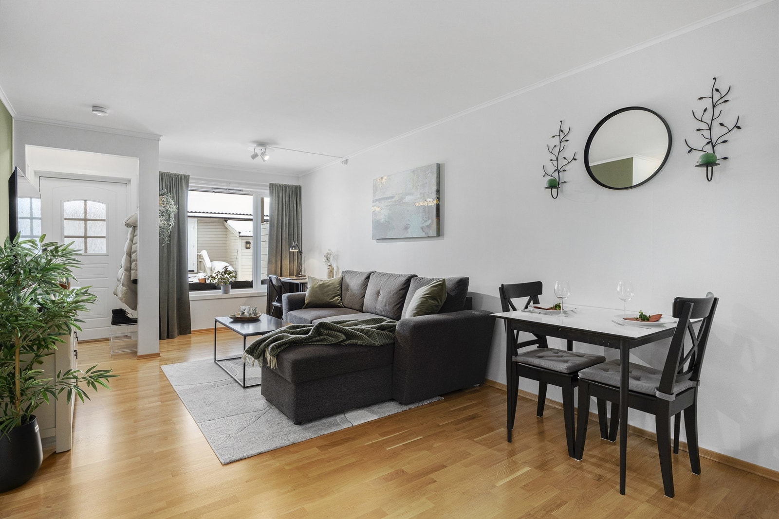 Lys stue med god plass til sofagruppe, spisestue og tilhørende møblement. Galleribilde