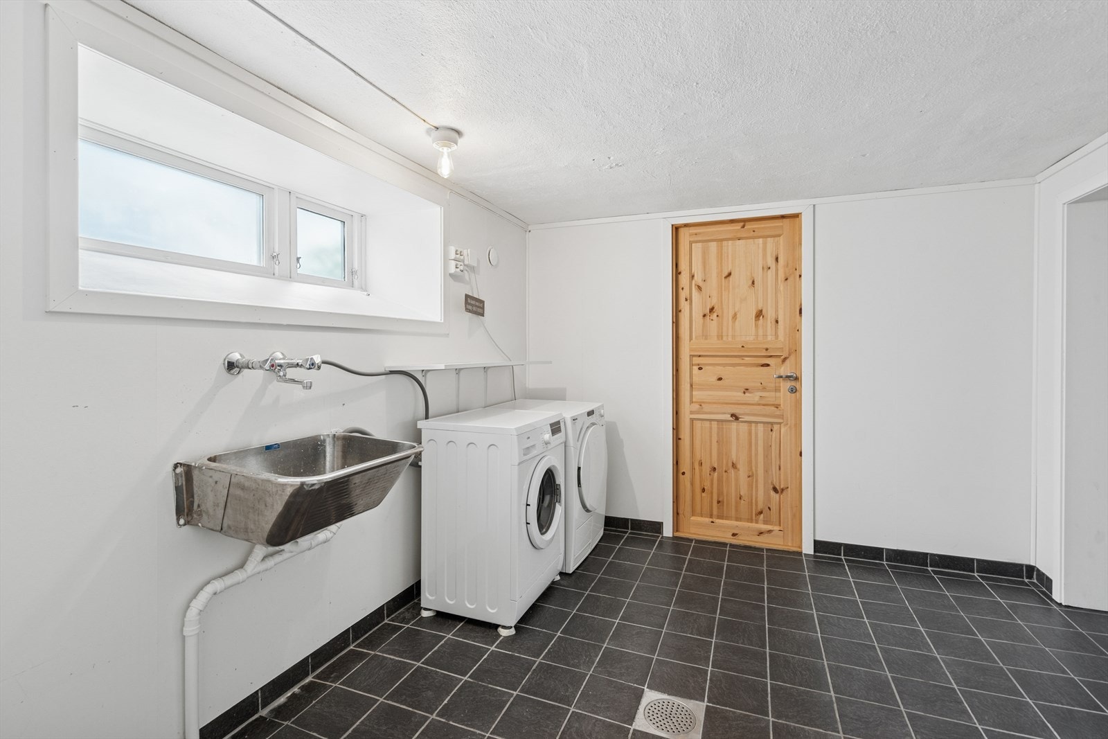 Stort og praktisk vaskerom med utslagsvask opplegg til vaskemaskin og tørketrommel Galleribilde