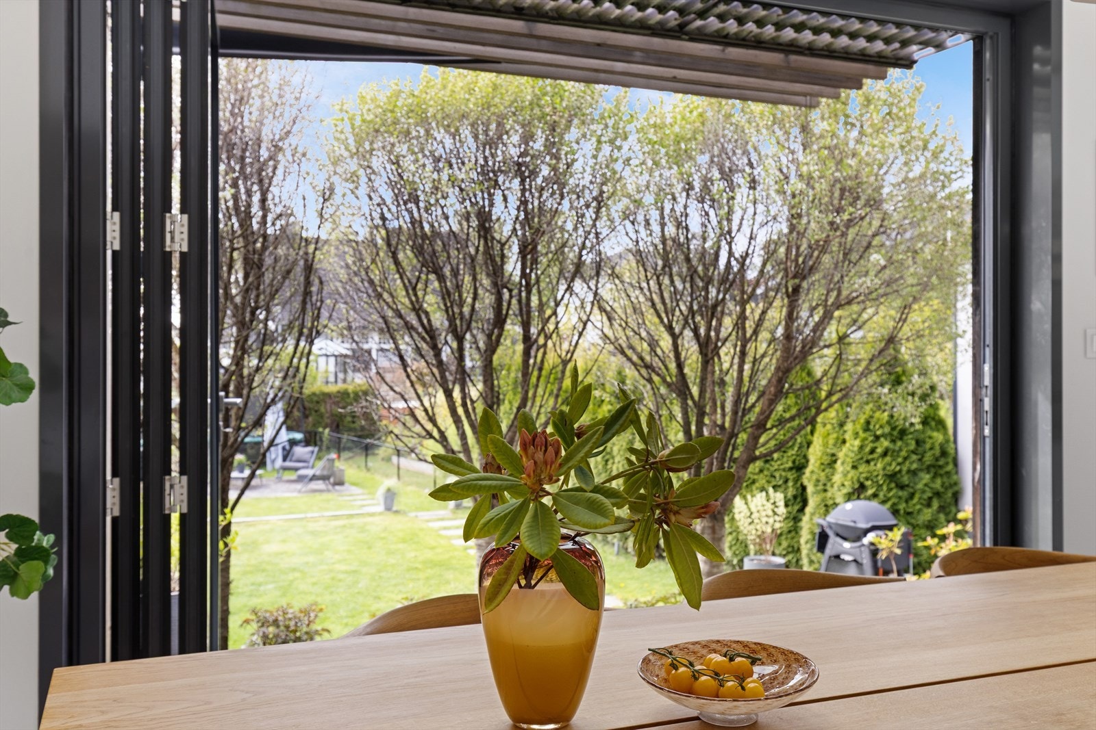 Fin utsikt til den frodige hagen fra kjøkkenet som gir en følelse av ro. Galleribilde