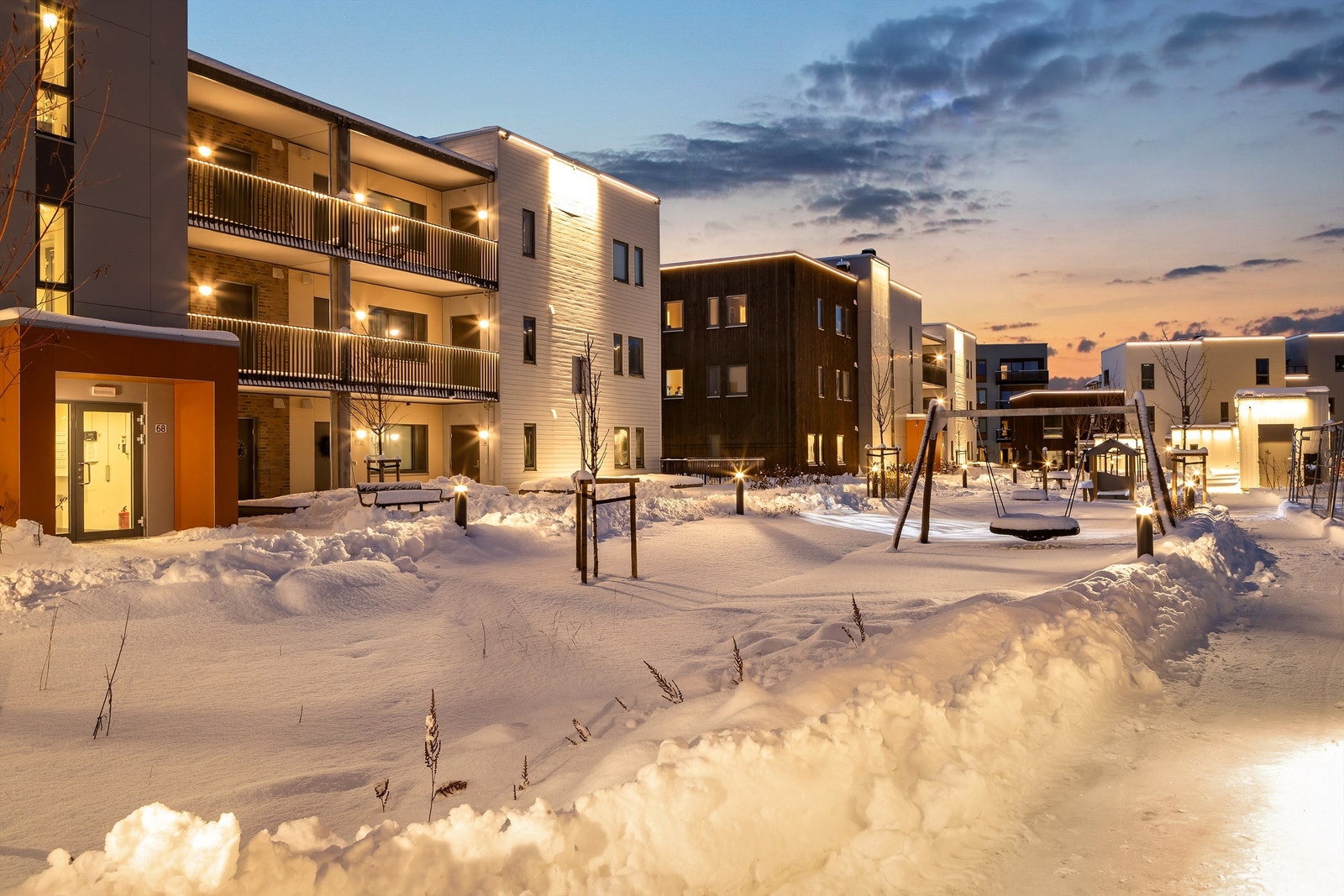 Rundt boligkomplekset er det fine fellesområder med lekeplass, grøntarealer og diverse beplantning Galleribilde