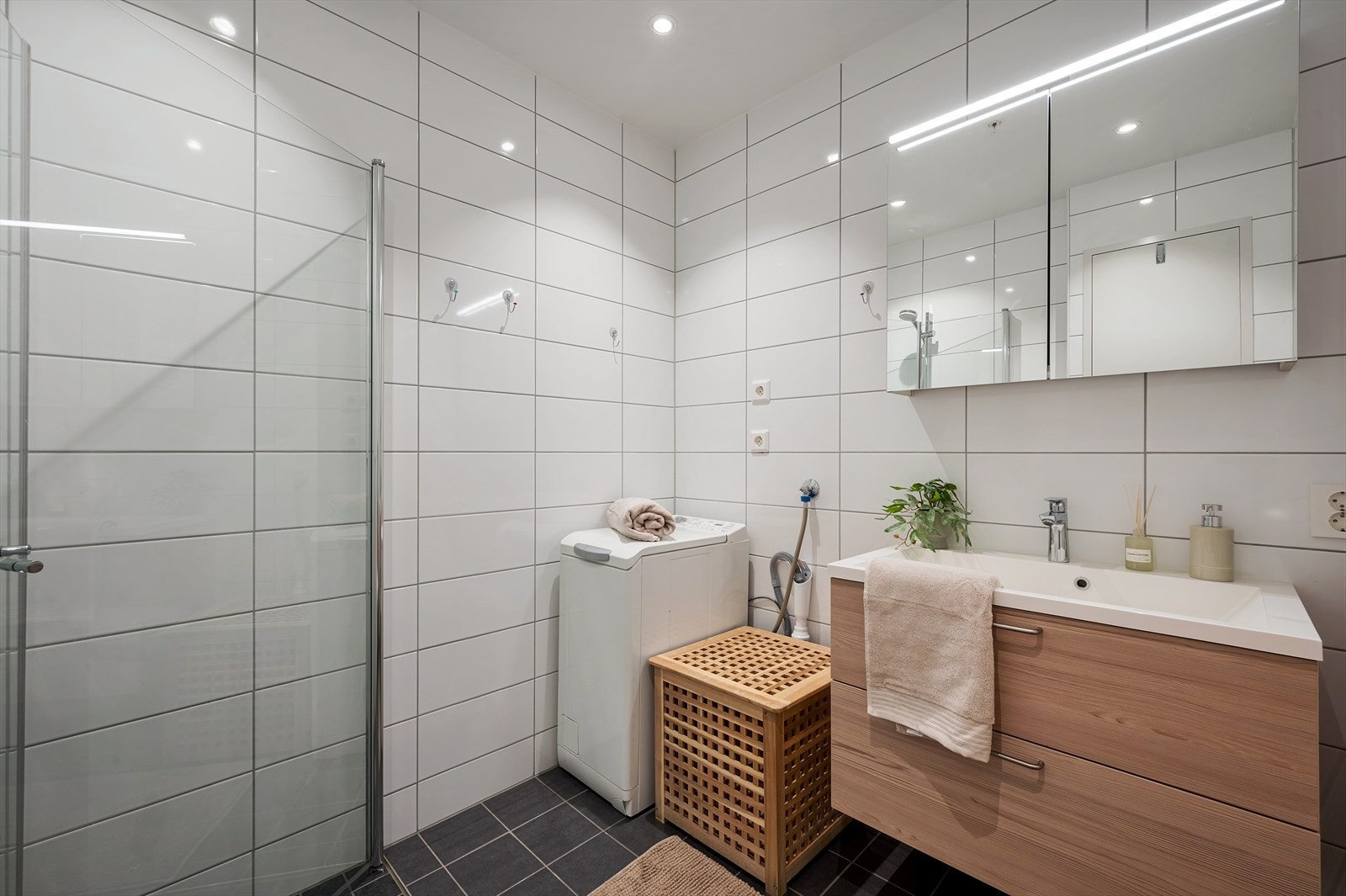 - Badet er innredet med blant annet opplegg for vaskemaskin og praktisk benkeskap med skuffer og servant, samt speil med integrert belysning og oppbevaringsmulighet - Galleribilde