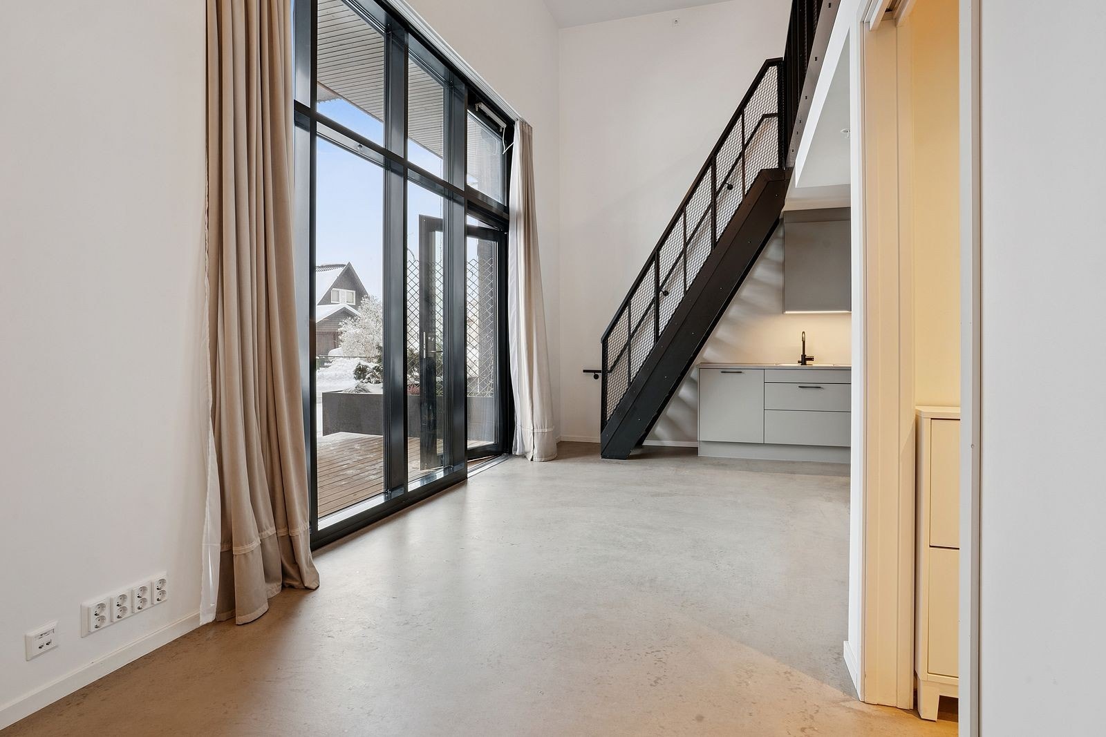 Stor og åpen stue/kjøkken-løsning med god plass til både sofa og spisebord Galleribilde