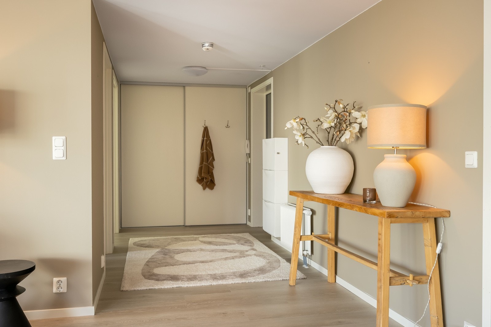 Man ønskes velkommen inn i en stor og åpen entré med mye godt med lagring innenfor skyvedørene. Galleribilde