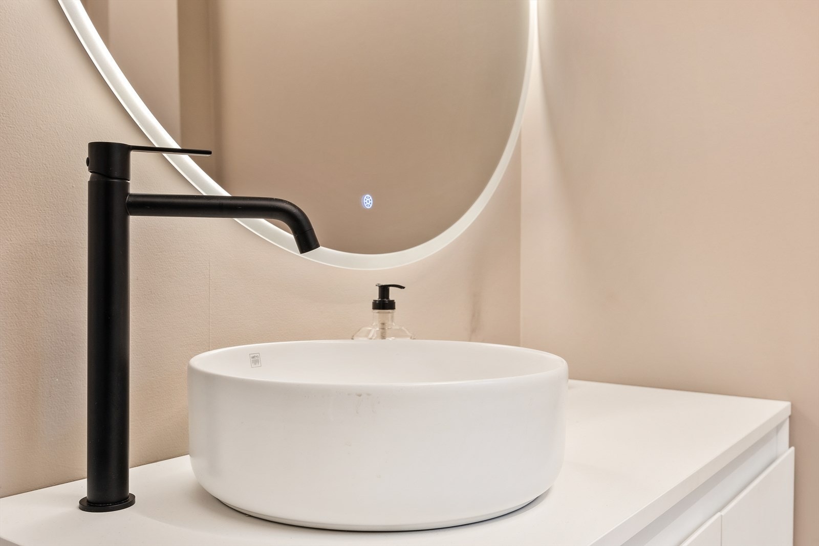 Innredningen har glatte fronter, servant og et speil med integrert belysning Galleribilde