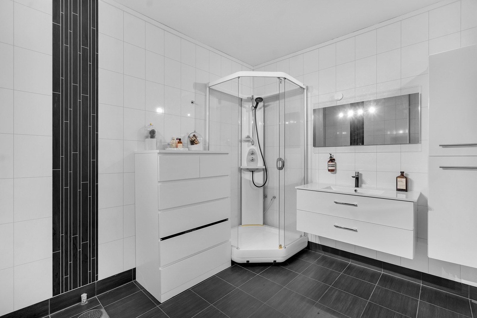 Pent fislagt bad med dusjkabinett, innredning med nedfelt servant, toalett og varmekabler i gulv Galleribilde