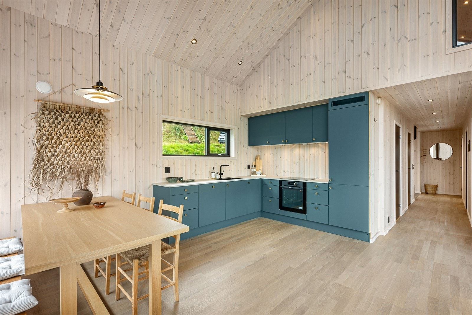 Kjøkkeninnredningen har slette fronter og laminert benkeplate Galleribilde