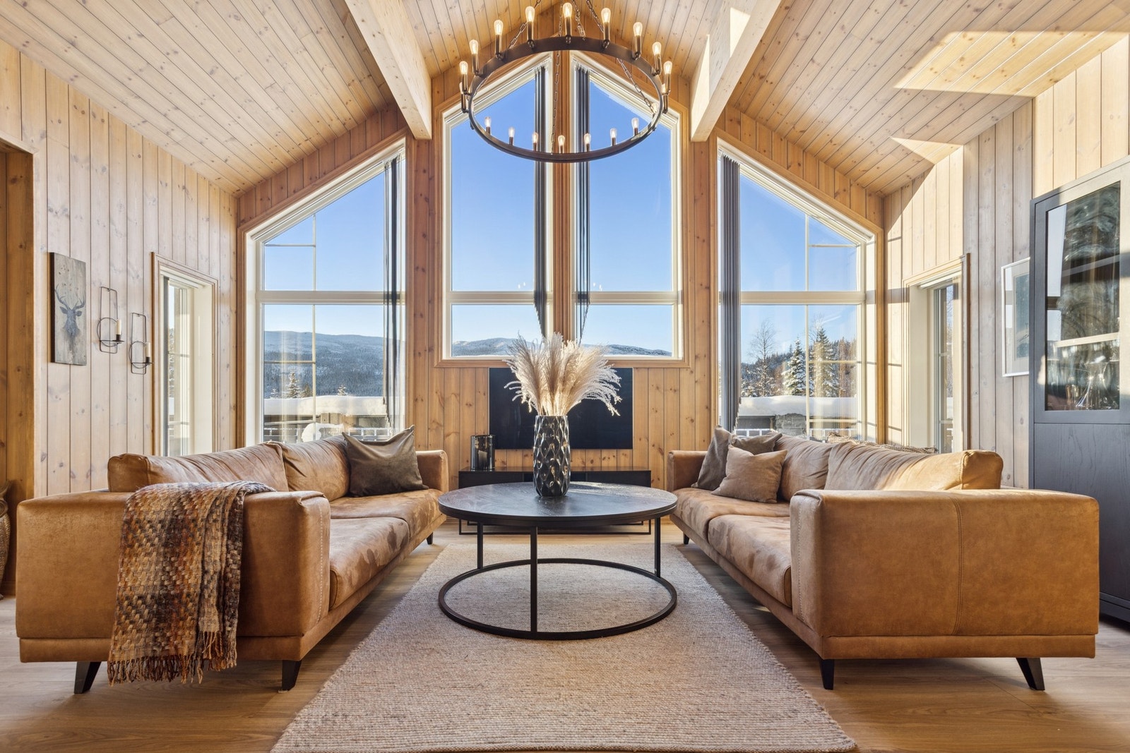 Hyttens hjerte - luftig stue med åpen himling og store vindusflater. Her kan man leve ut hyttedrømmen. Galleribilde