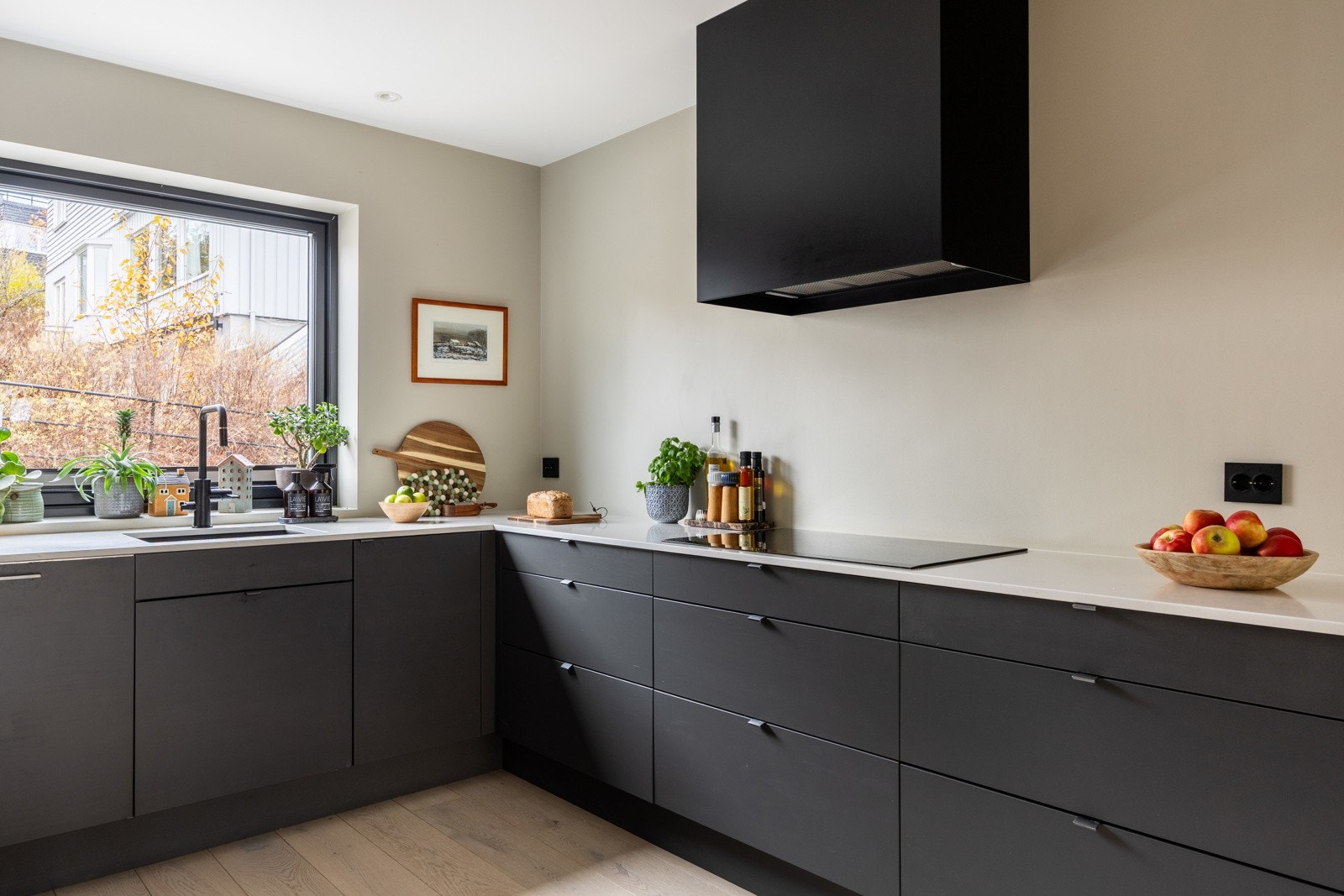 Det er med underlimt vask, ettgreps kjøkkenarmatur med spylefunksjon og stoppekran for oppvaskmaskin. Integrert oppvaskmaskin fra Miele. Avtrekksvifte fra Røroshetta. 80 cm bred induksjonstopp fra Siemens. Galleribilde