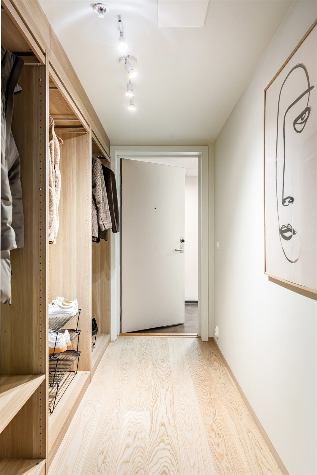 I den felles gangen finnes et romslig, åpent garderobeskap som utnytter hele høyden fra gulv til tak, og gir svært gode og oversiktlige oppbevaringsmuligheter. Galleribilde