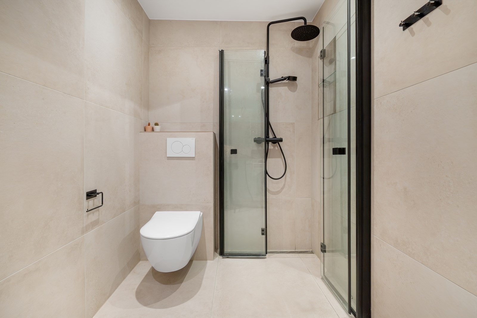 Pent flislagt baderom fra 2021 med innfelte downlights i himlingen. Galleribilde