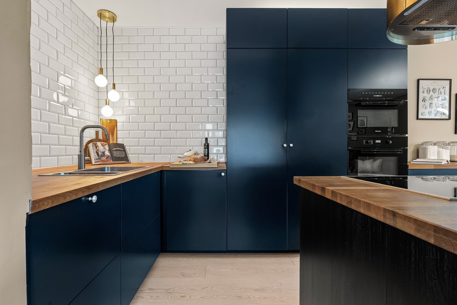 De matte frontene i dyp blå utførelse kombinert med benkeplate i tre, skaper en varm og harmonisk kontrast. Galleribilde