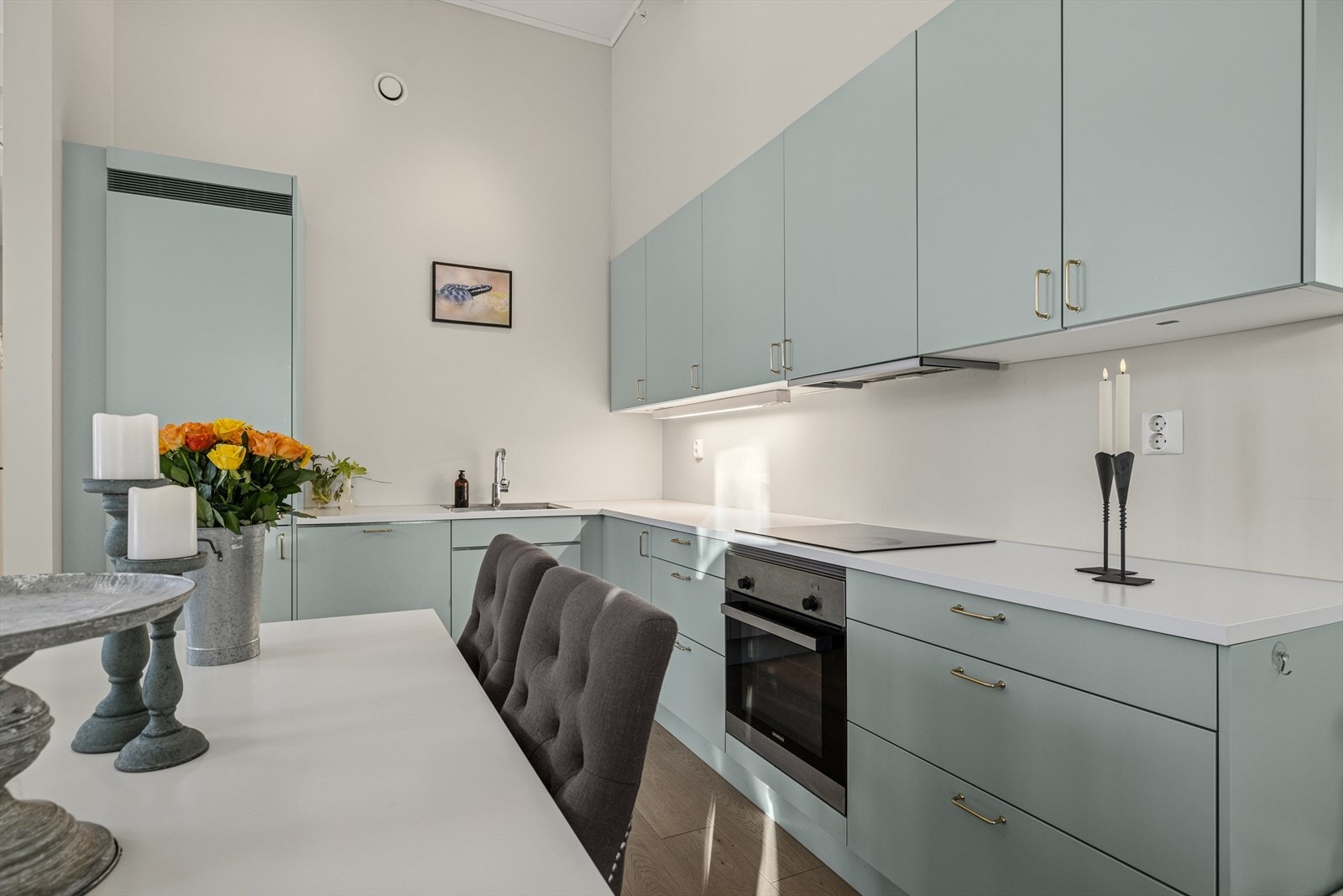 Videre byr kjøkkenet på detaljer som belysning under overskap, kombinert kjøl- og fryseskap og stor kjøkkenvask. Galleribilde