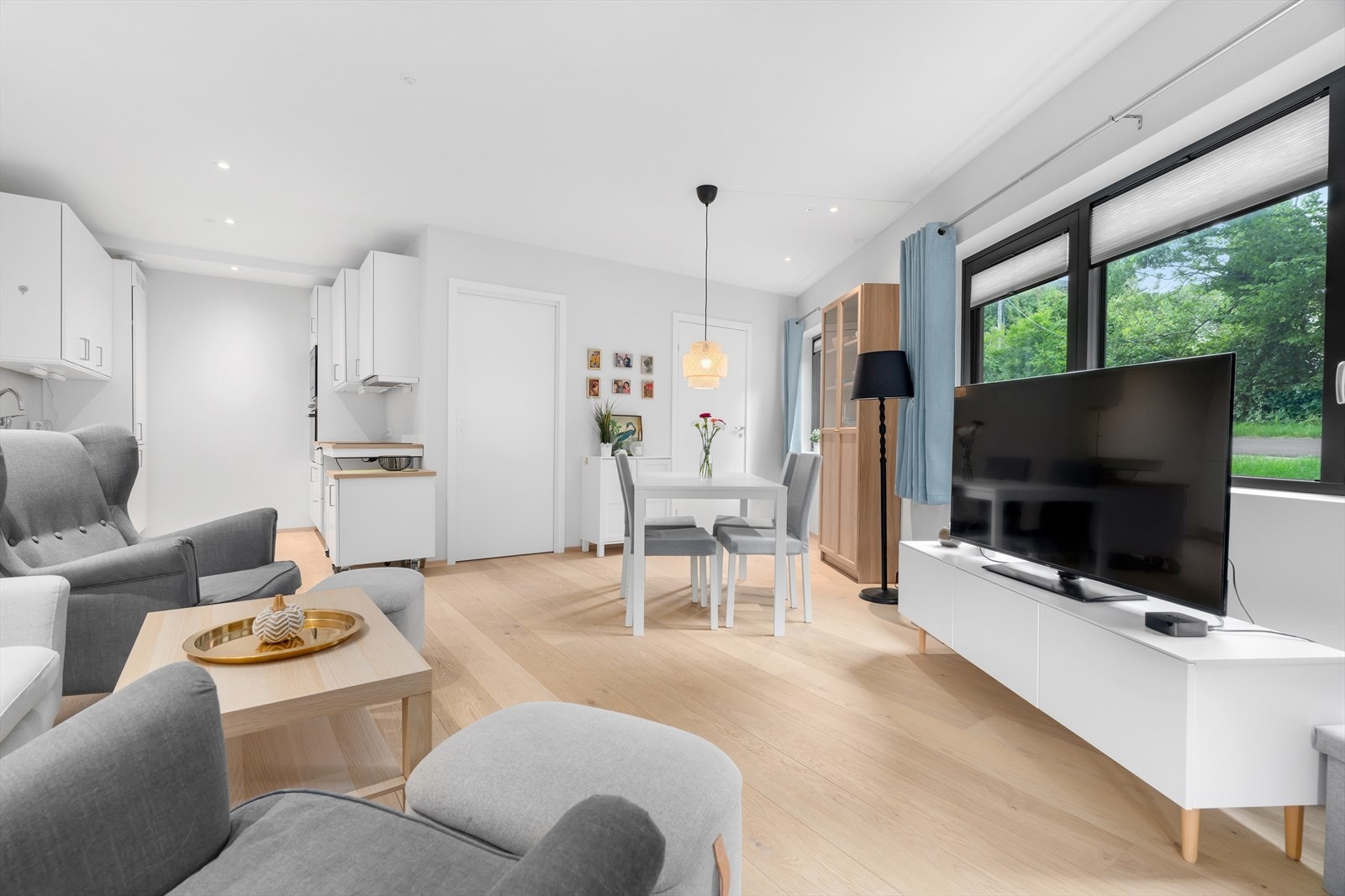 Åpen stue/kjøkken-løsning med naturlig plassering for spisebord. Galleribilde