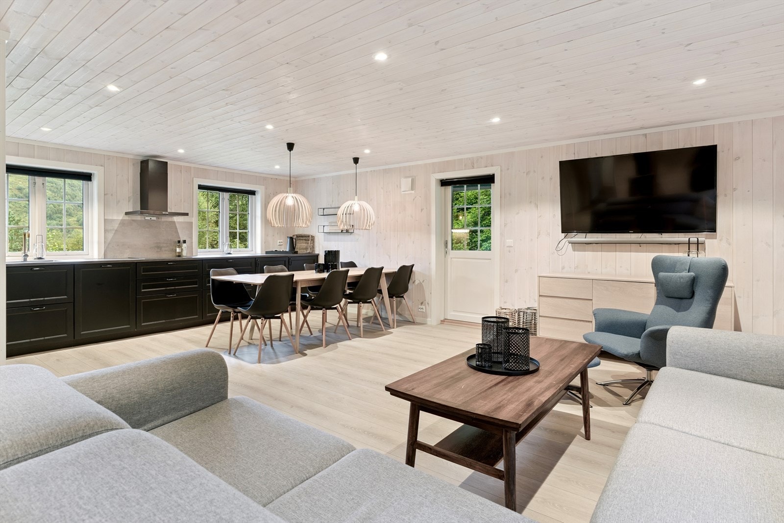 Stove og kjøkken ligg i åpen løysing og skapar ei perfekt sone for familietid på hytta Galleribilde