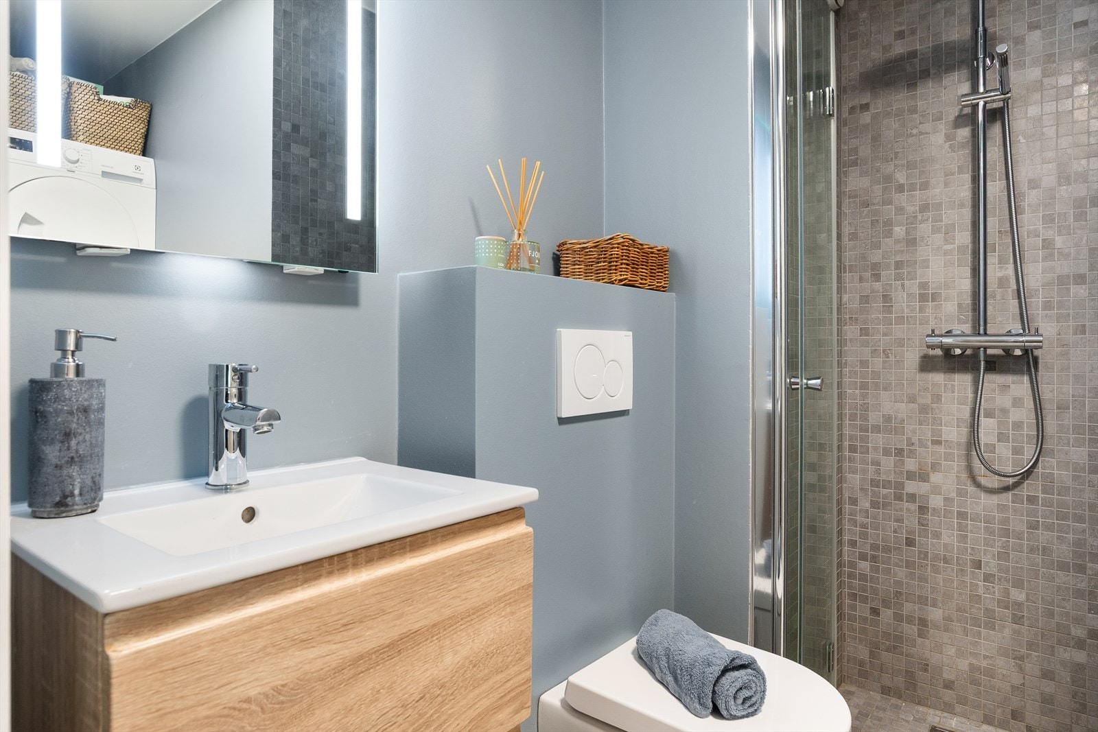 Badet er utstyrt med vegghengt toalett og servant med underskap. Galleribilde